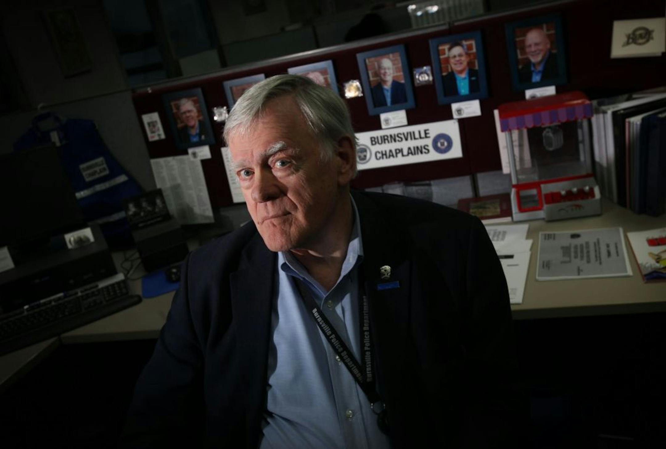John Campbell is the head chaplain of the Burnsville Police Department. Other chaplains serving the department are pictured behind him.