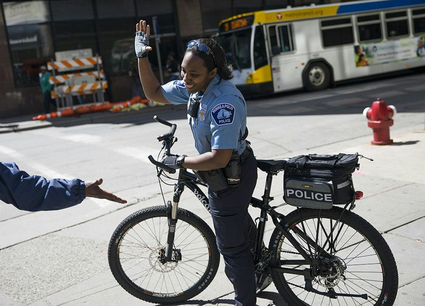 Minneapolis officer Yolanda Wilks gave a high-five to a woman telling her she had just passed a background check for a job.