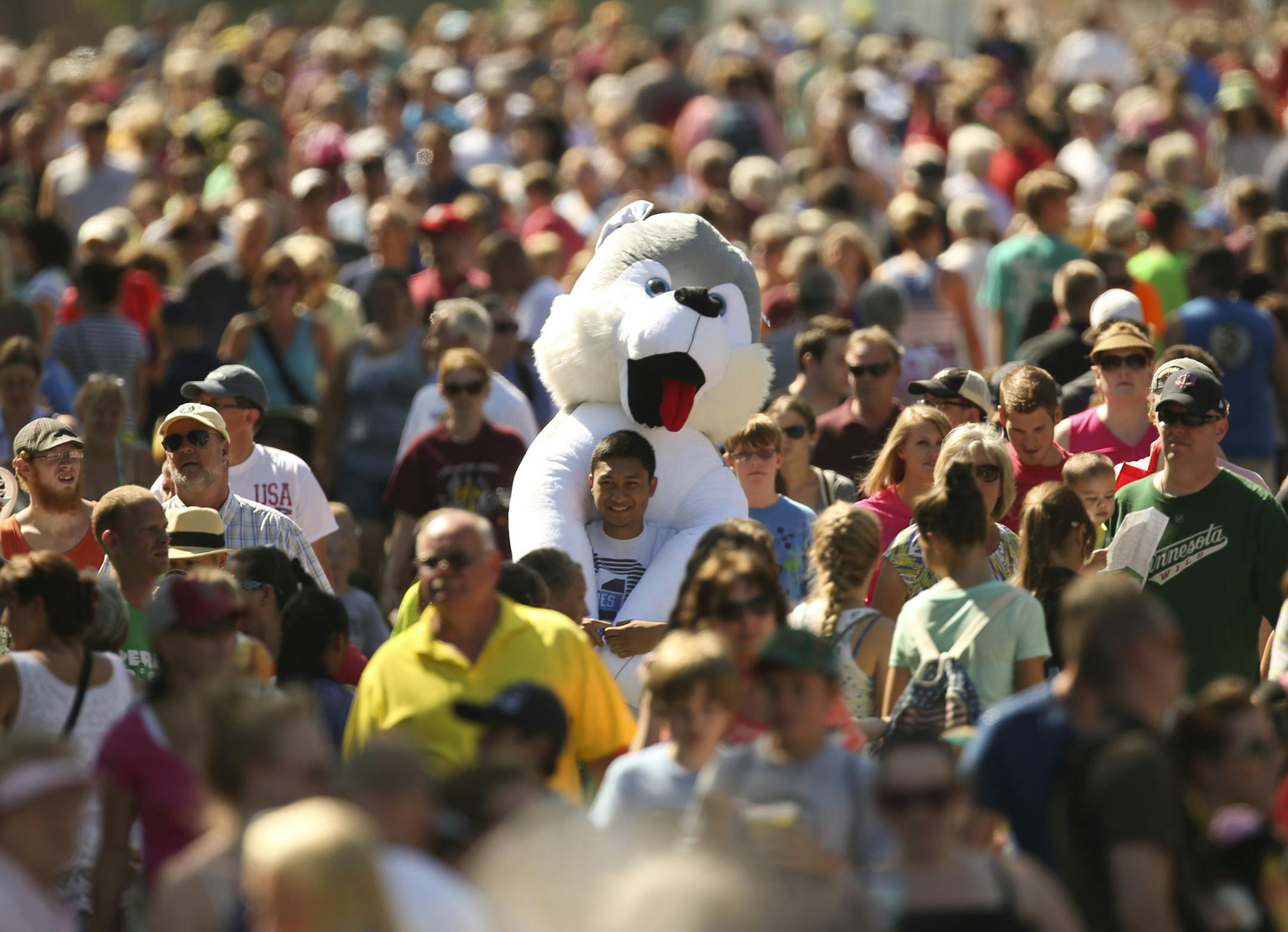 Everything lined up for the first day of the Minnesota State Fair on Thursday: the weather, the cows, the crowds at the Dough-Sant (doughnut + croissant) stand. One lucky guy, Ravem Noguerraza of Coon Rapids, even got to carry around a giant stuffed dog that his buddy won.