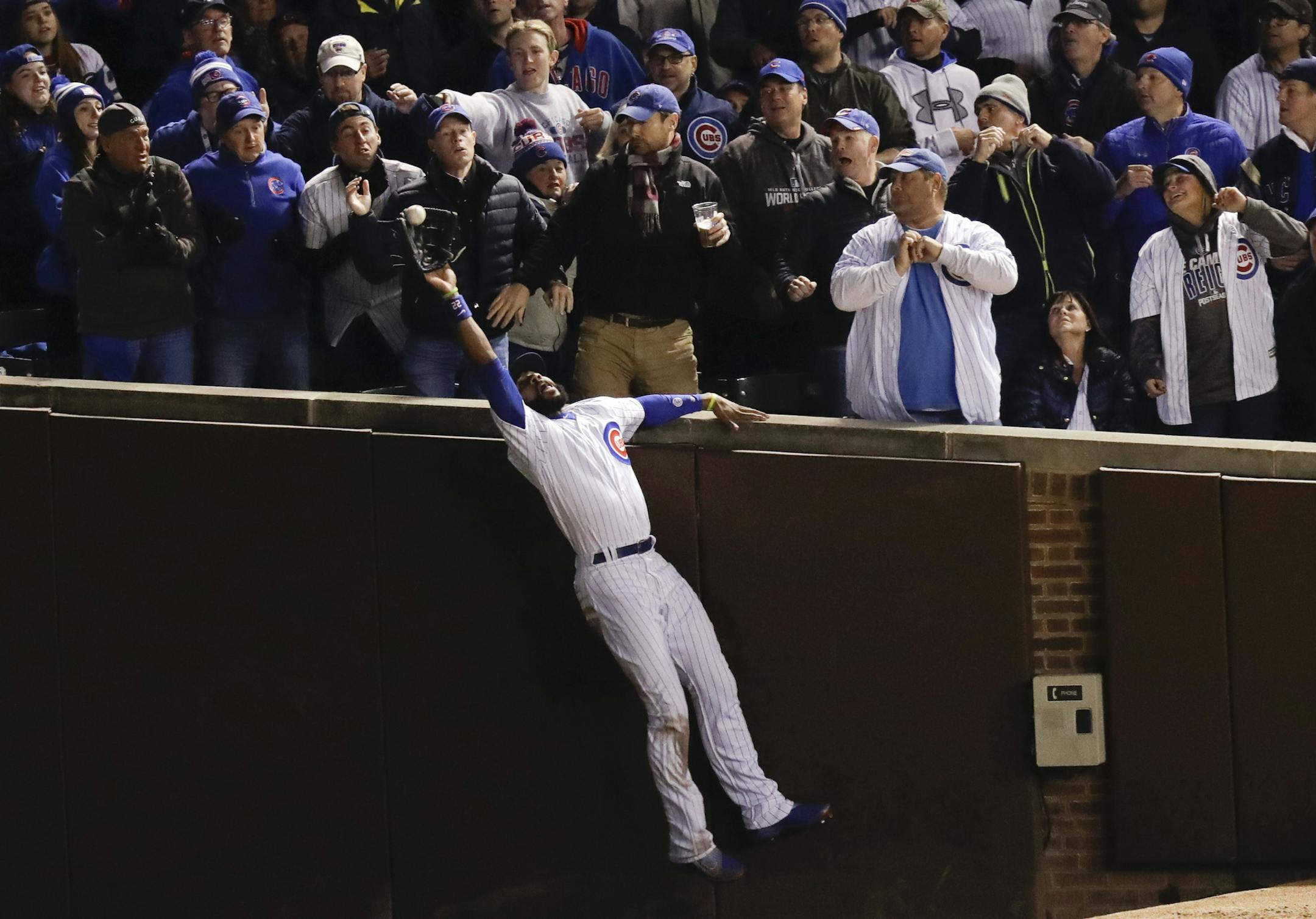 Chicago Cubs right fielder Jason Heyward catches a fly ball hit by Cleveland Indians' Trevor Bauer during the third inning of Game 5 of the Major League Baseball World Series Sunday, Oct. 30, 2016, in Chicago. (AP Photo/Charles Rex Arbogast)