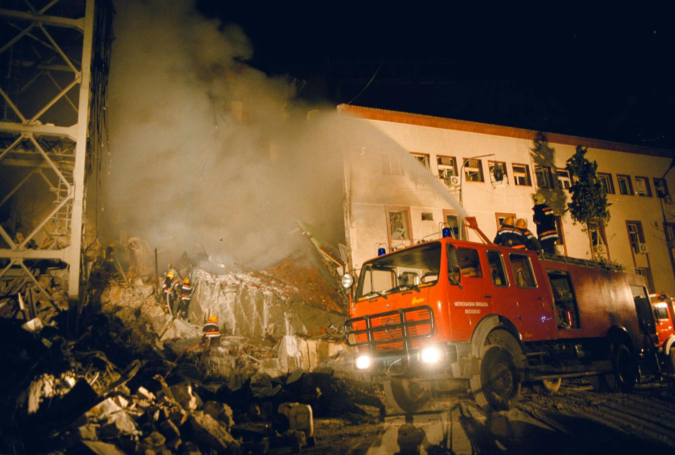 Firefighters work to quench the blaze at the Serbian state television station building in downtown Belgrade, early Friday, April 23, 1999. The Serbian TV building was hit by NATO air-strikes, knocking the country's main tv station off the air and leaving an umknown number of casualties. (AP PHOTO/str)***YUGOSLAVIA OUT**INTERNET OUT*** ORG XMIT: BEL116