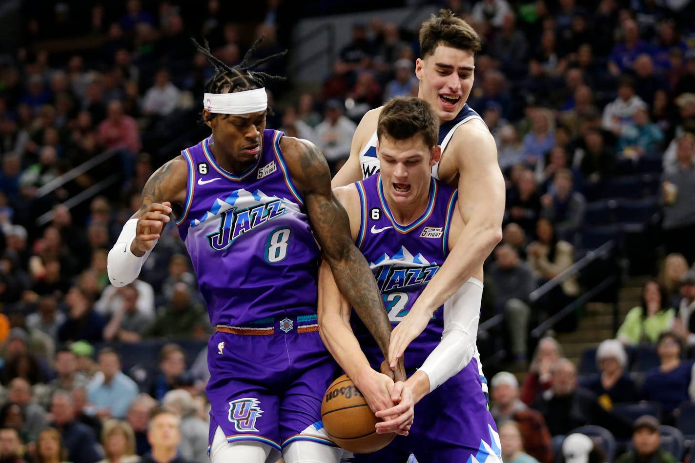 Utah Jazz forward Jarred Vanderbilt (8) and center Walker Kessler, center, box out Minnesota Timberwolves center Luka Garza, right, in the third quarter during an NBA basketball game Monday, Jan. 16, 2023, in Minneapolis. (AP Photo/Andy Clayton-King)