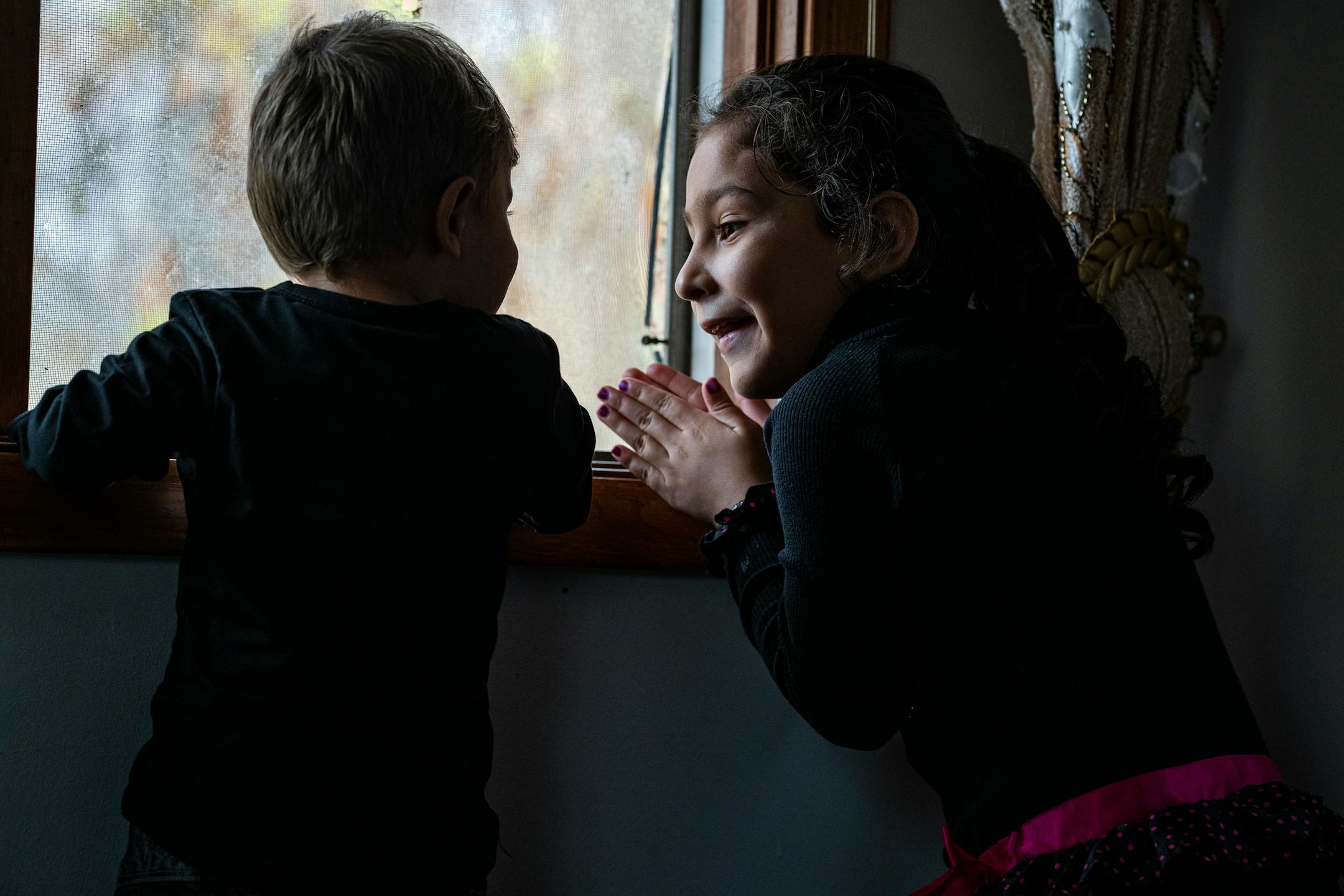 Maryam Mulakhail, 5, makes Mostafa Momand, 2, feel welcome. Momand's family of ten is staying with them until they move to their new apartment in Bloomington.
