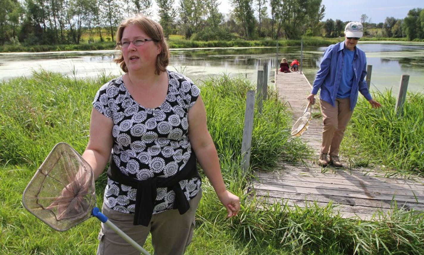 Former Minnesota New Country School student Becky Pollack, now director of the Ney Nature Center, and biologist Judy Helgen looked for frogs at the Ney Pond in Henderson, Minn. Pollack was among the students who discovered deformed frogs in 1995.