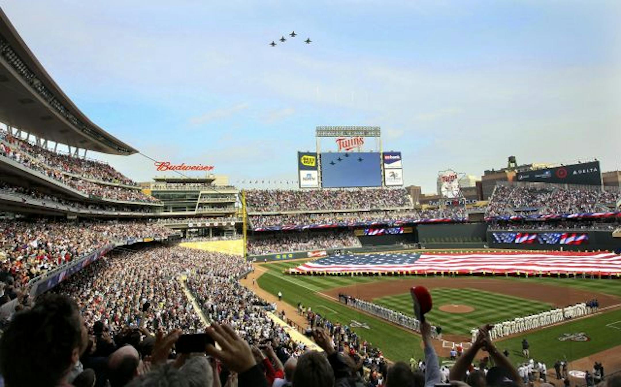 F-16's from the 148th fighter wing in Duluth do a fly over prior to the start of the first regular season in the Twins new ballbark Target Field.