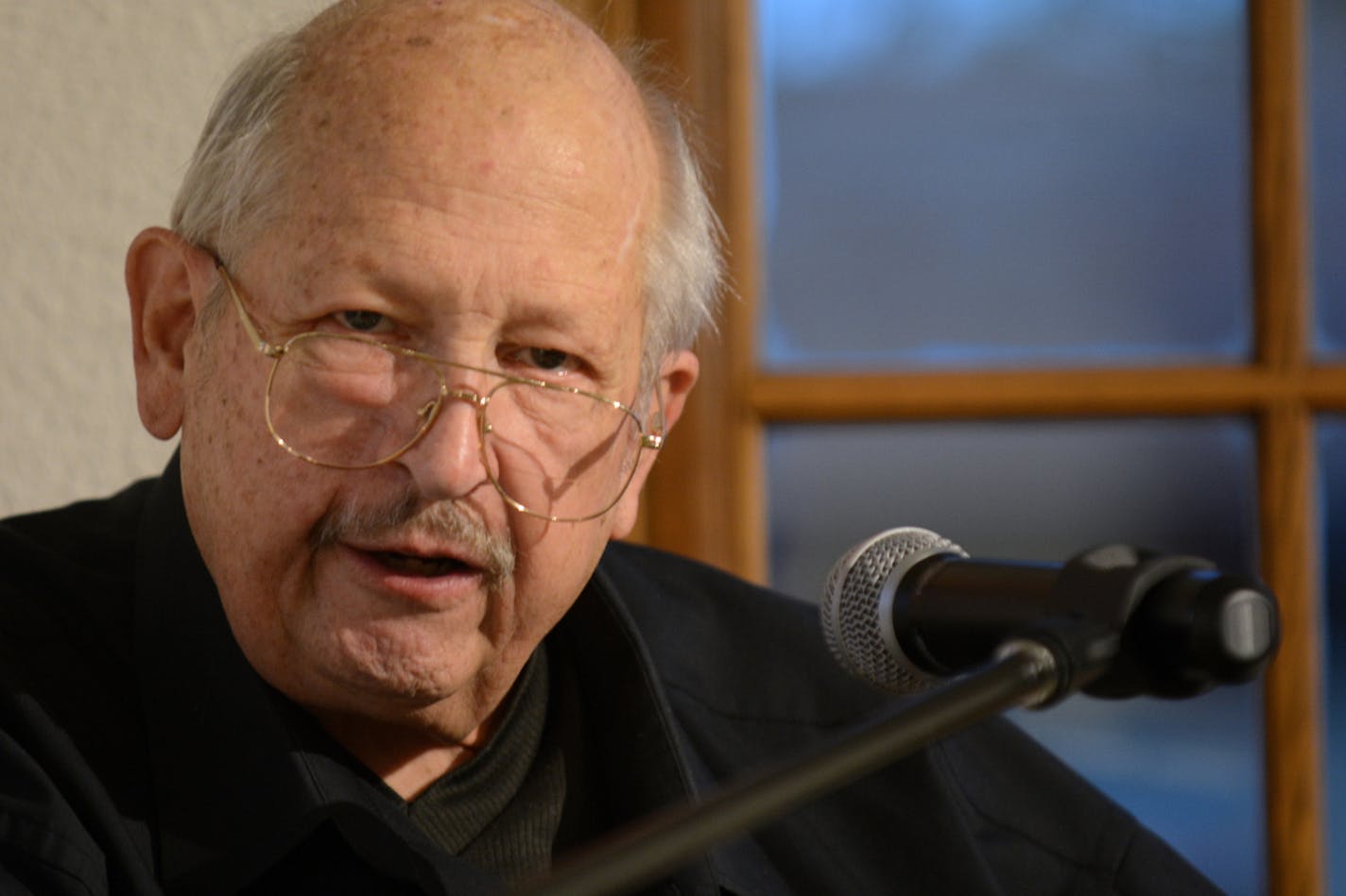 Poet John Rezmerski reading his latest work, a chapbook titled "Cataloging the Flow - Elegy," before a live audience at Twin Rivers Council for the Arts Emy Frentz Gallery in Mankato, Minnesota on Sept. 22, 2016. Tim Nelson | MPR News