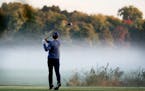 A golfer, who wished not to be identified, hits a tee shot on Hiawatha Golf Course, which was consumed by fog near dawn Tuesday in Minneapolis. ]
