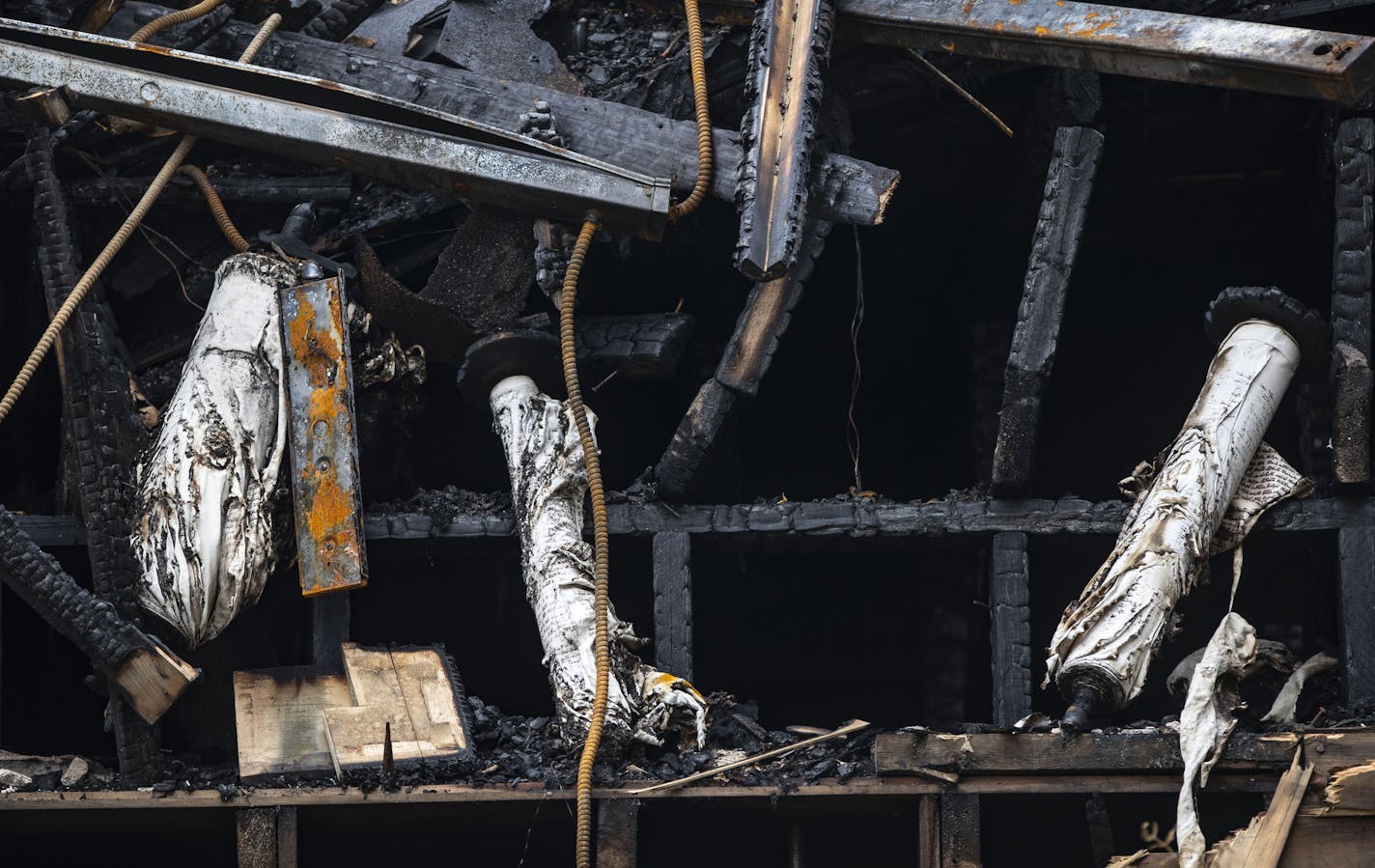 FILE - Scrolls from the Adas Israel Congregation synagogue that were burnt by the fire hang out the back of the destroyed building in September. ORG XMIT: MIN1910251148358015