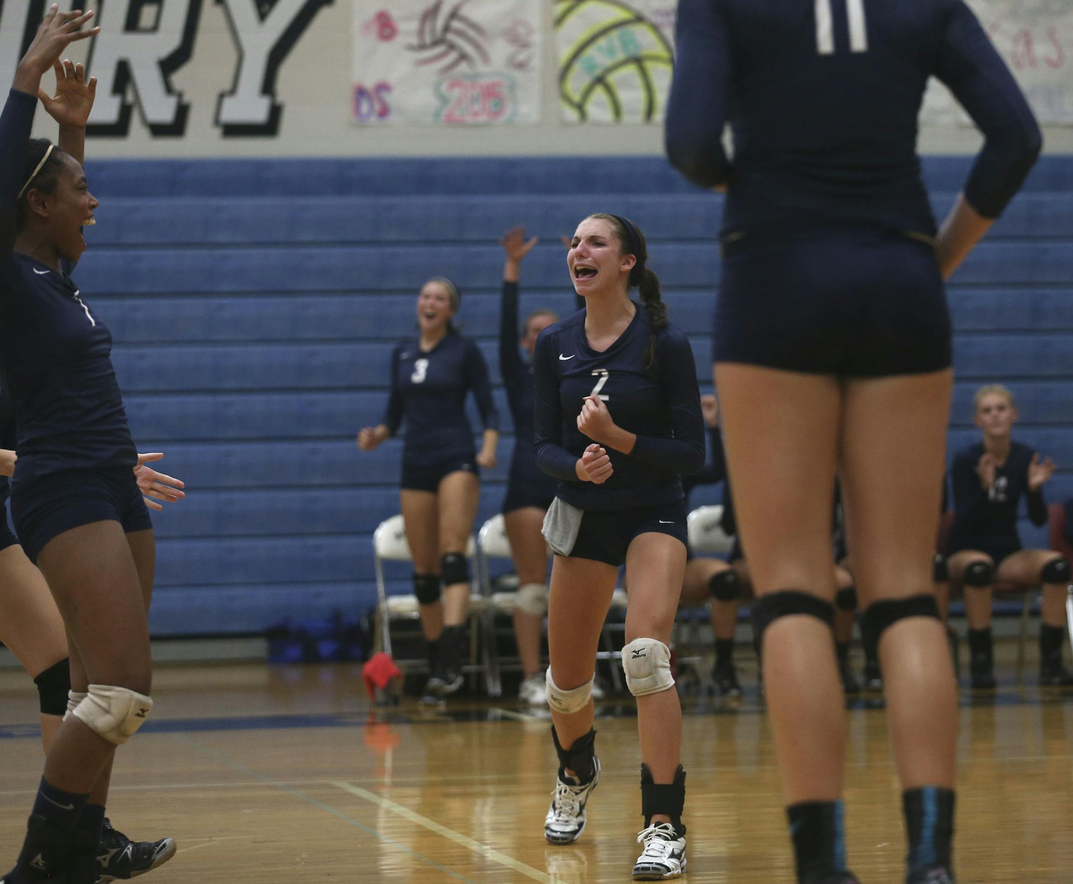 Sydney Hilley, freshman volleyball player at Champlin Park celebrated with her teammates after they scored during their first set against Roseville High School in Roseville, Min., Tuesday, August 27, 2013. ] (KYNDELL HARKNESS/STAR TRIBUNE) kyndell.harkness@startribune.com