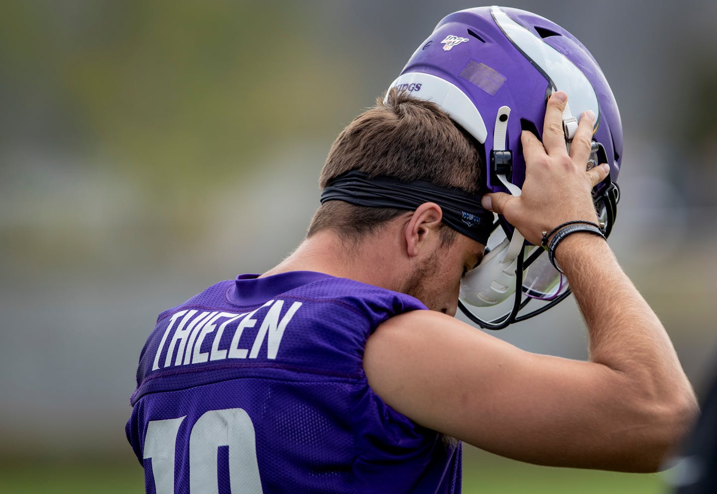 Vikings wide receiver Adam Thielen put on his helmet before practice. An NFL rule change insists all players' helmets be tested and certified jointly by NFL- and NFLPA-appointed biomechanical engineers.