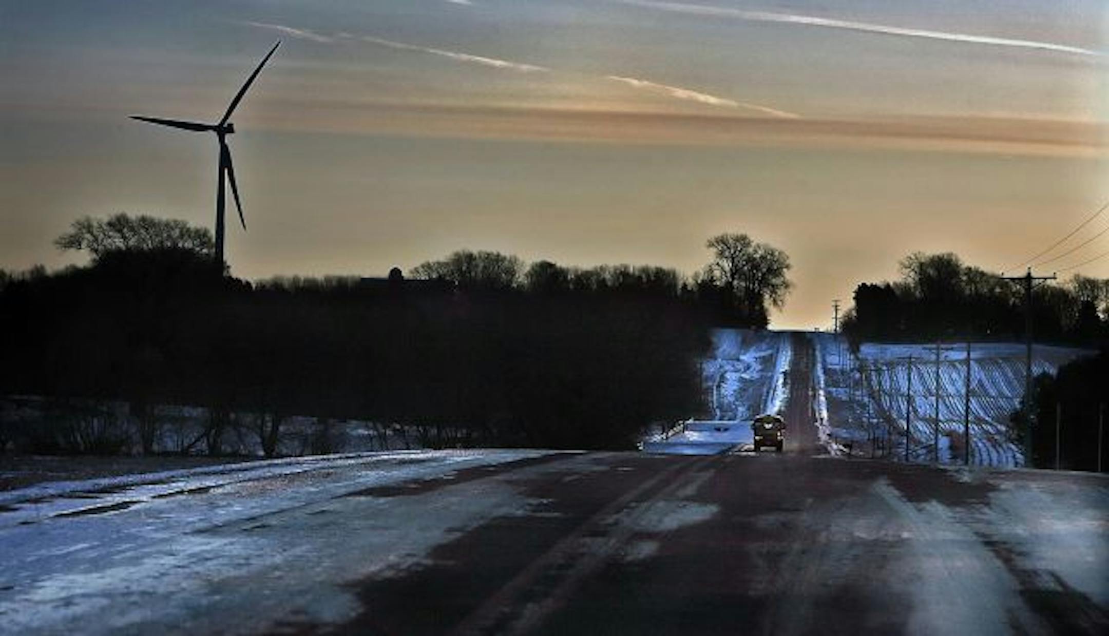 A school bus carried students along Wall St. Rd in rural Northfield, past a 1.65 megawatt wind turbine owned by Carleton College. The turbine was built five years ago and according to an informational sign posted at the site, is capable of producing about 40% of the colleges electrical annual electricity or enough power for 600 homes.