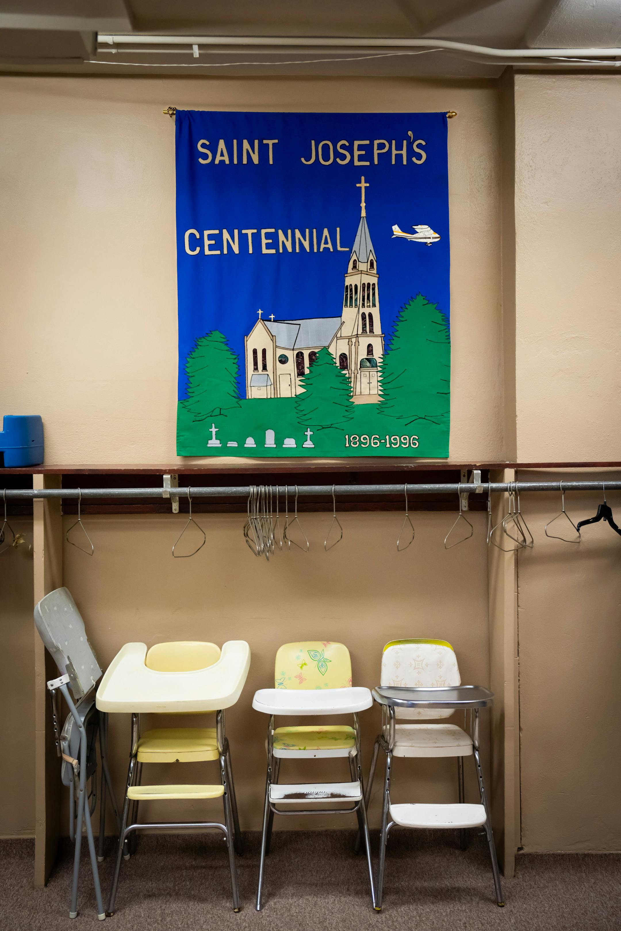 A Saint Joseph's Church centennial banner hangs in the Church's parochial school basement.