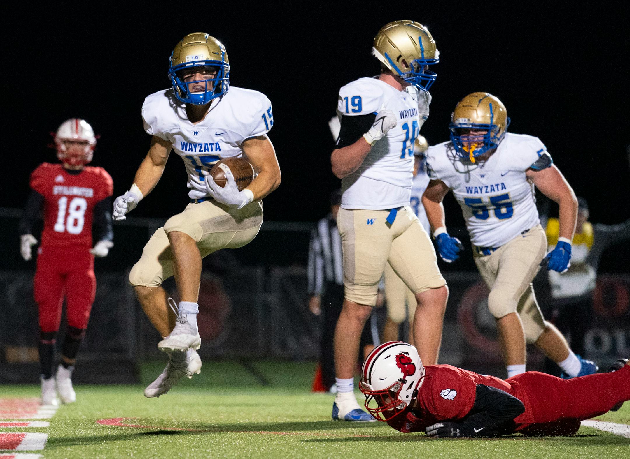 Wayzata High School wide receiver Drew Berkland (15) is scores a touchdown to give his team a 14-7 lead over Stillwater in the fourth quarter of a Class 6A football playoff game Friday, Nov. 5, 2021 in Stillwater, Minn.. No.4 Wayzata upset No.1 Stillwater 28-7. ]