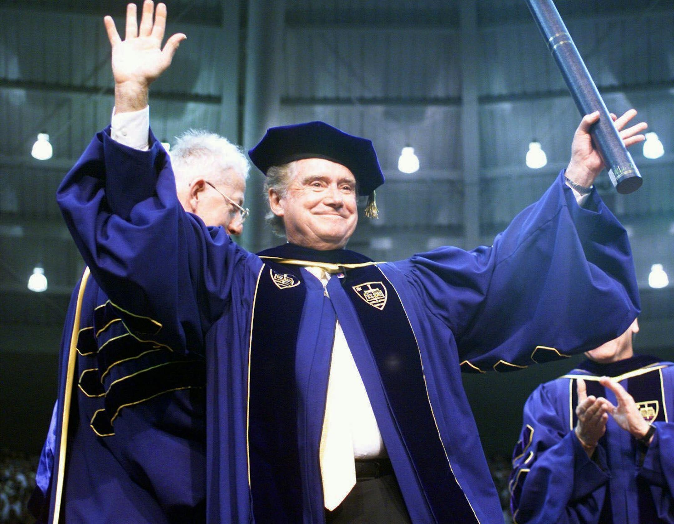 FILE - In this May 16, 1999, file photo, Regis Philbin, a Notre Dame graduate, waves to the crowd after receiving an honorary degree during Notre Dame's 154th commencement exercises in South Bend, Ind. Philbin, who died last week at 88, has been buried at the university's Cedar Grove Cemetery, following a private funeral service Wednesday, July 29, 2020. (AP Photo/Joe Raymond)