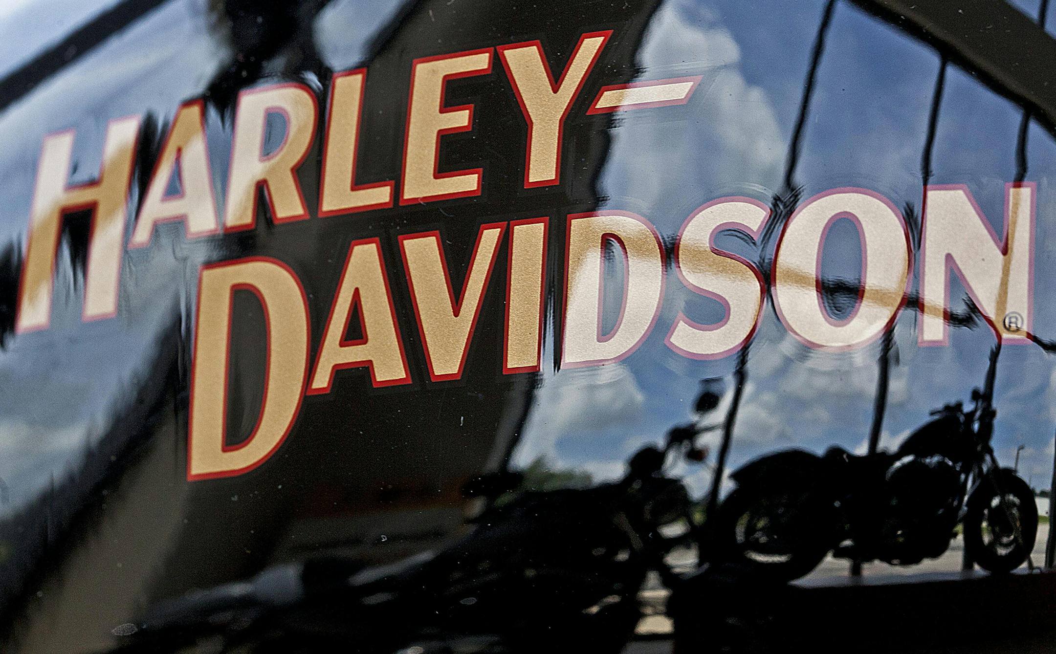 FILE - In this July 20, 2010 file photo, motorcycles are reflected in a gas tank at a Harley Davidson dealer in New Berlin, Wis. Harley-Davidson's first-quarter profit edged up, benefiting from a reduced tax rate. But the motorcycle maker's revenue missed expectations and the company lowered its full-year forecast for motorcycle shipments, citing increased discounting among its rivals. The stock dropped almost 10 percent in afternoon trading Tuesday, April 21, 2015. (AP Photo/Morry Gash, file) O