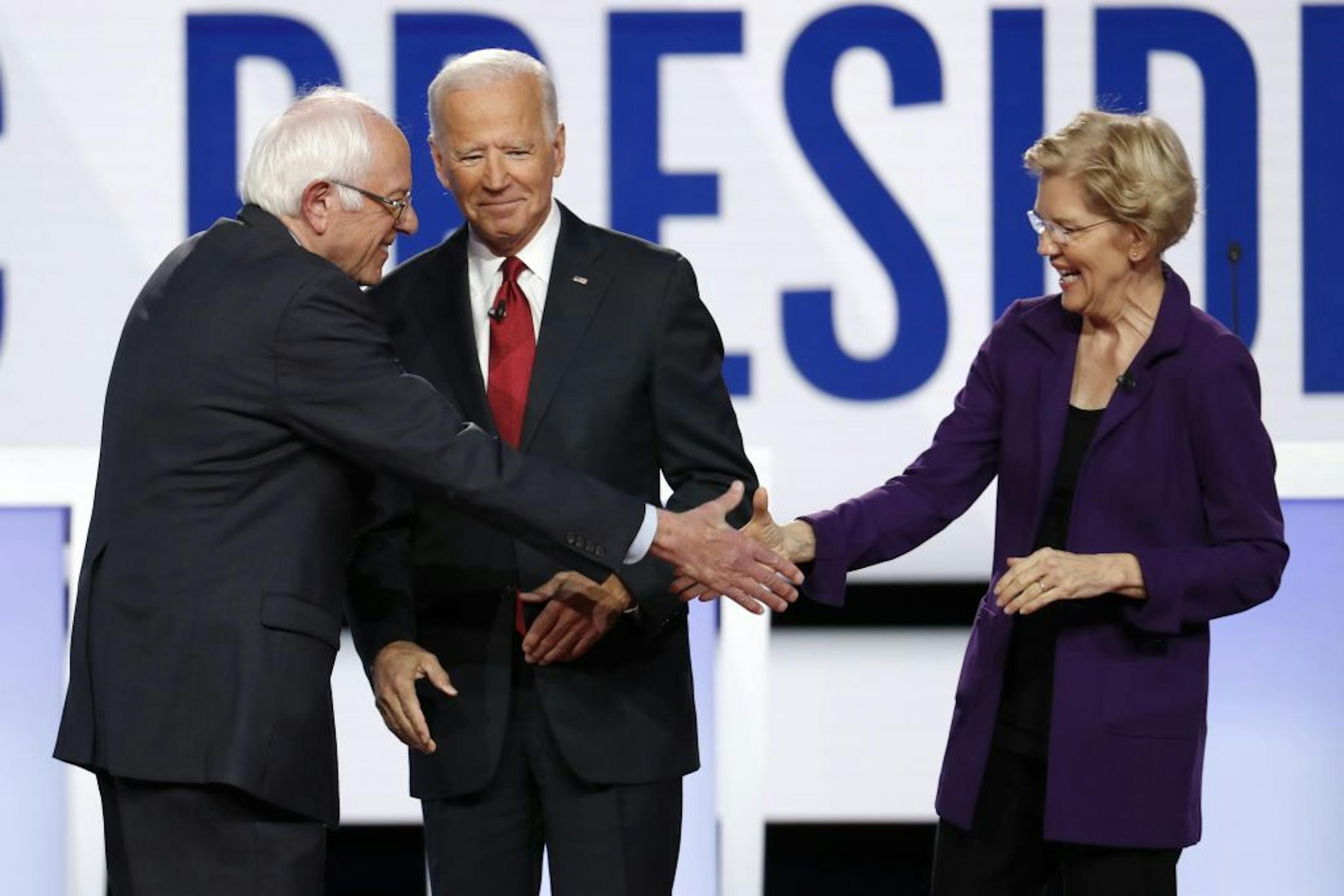 Sen. Bernie Sanders, I-Vt., left, former Vice President Joe Biden and Sen. Elizabeth Warren, D-Mass., right, took the stage Tuesday at the Democratic presidential debate in Westerville, Ohio.