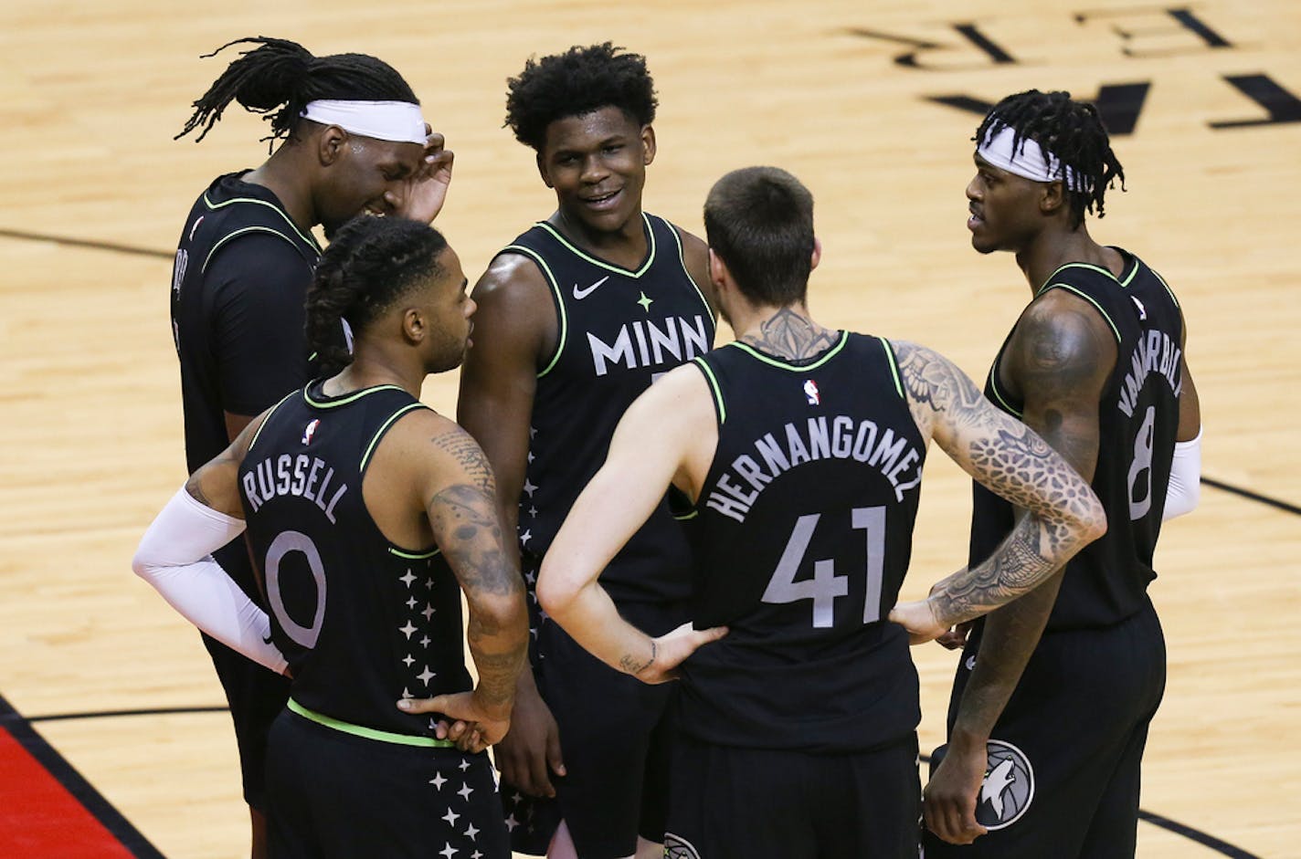 Minnesota Timberwolves forward Anthony Edwards (1) and teammates huddle during a game last season.