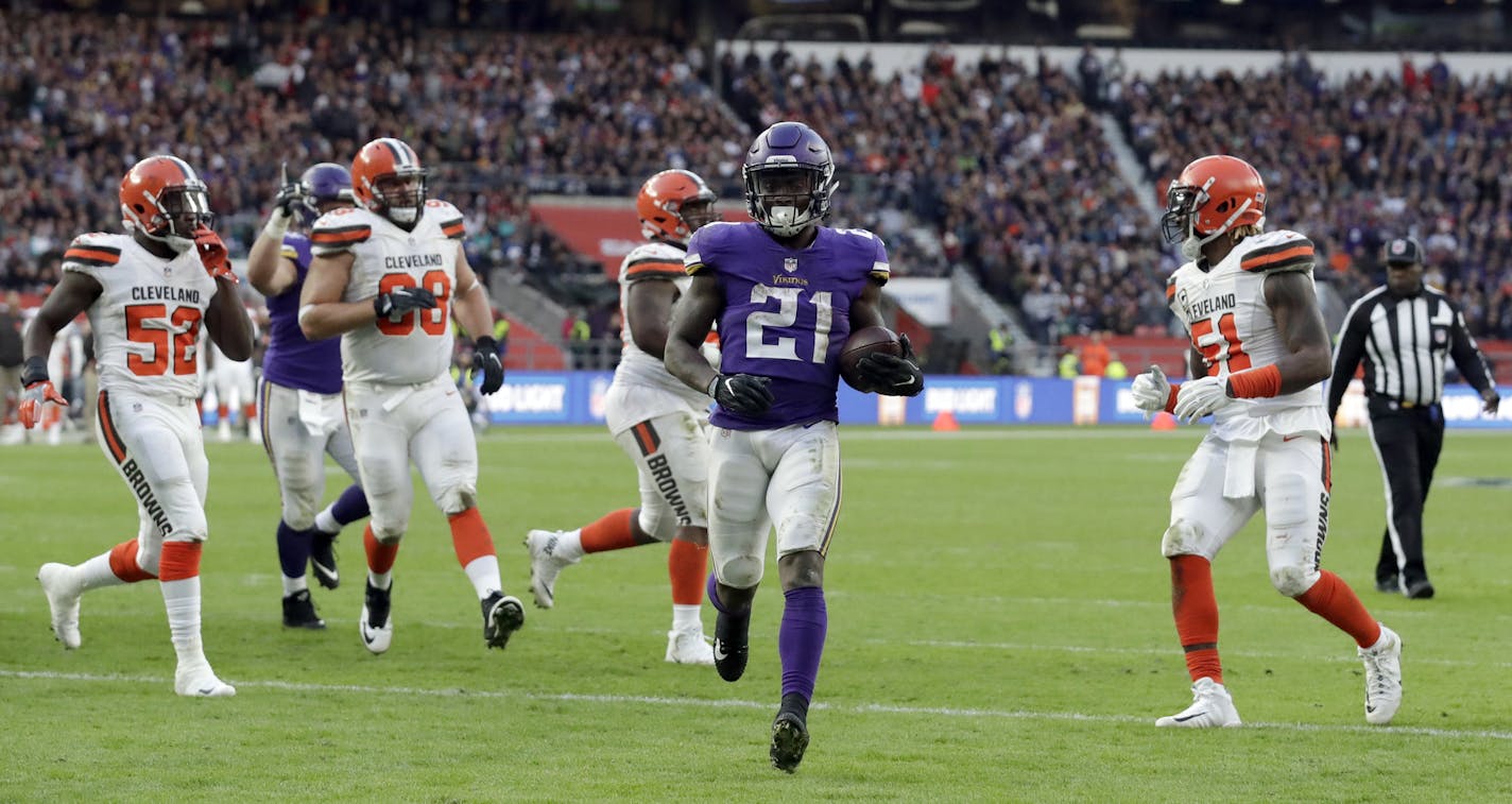 Minnesota Vikings running back Jerick McKinnon (21) scores on a 1-yard touchdown run during the second half of an NFL football game against Cleveland Browns at Twickenham Stadium in London, Sunday Oct. 29, 2017. (AP Photo/Matt Dunham)