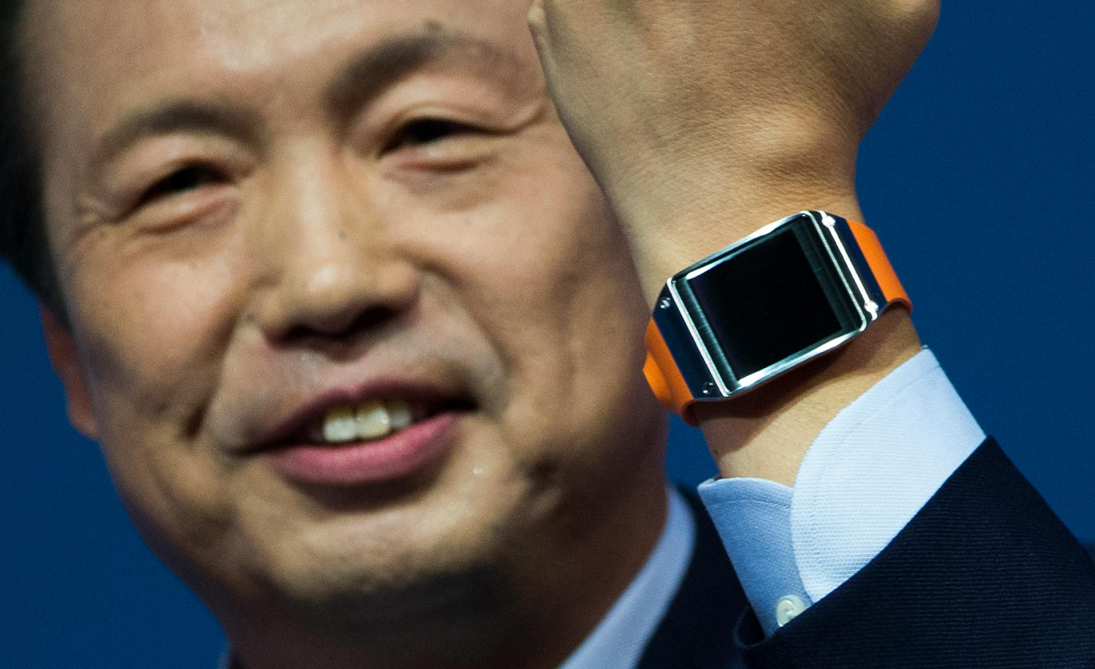 JK Shin, head of Samsung Mobile Communications, presents the Samsung Galaxy Gear in Berlin, Germany, Wednesday, Sept. 4, 2013. Samsung has unveiled a highly anticipated digital wristwatch well ahead of a similar product expected from rival Apple. The so-called smartwatch is what some technology analysts believe could become this year's must-have holiday gift. Samsung unveiled the Galaxy Gear on Wednesday in Berlin ahead of the annual IFA consumer electronics show. (AP Photo/Gero Breloer)