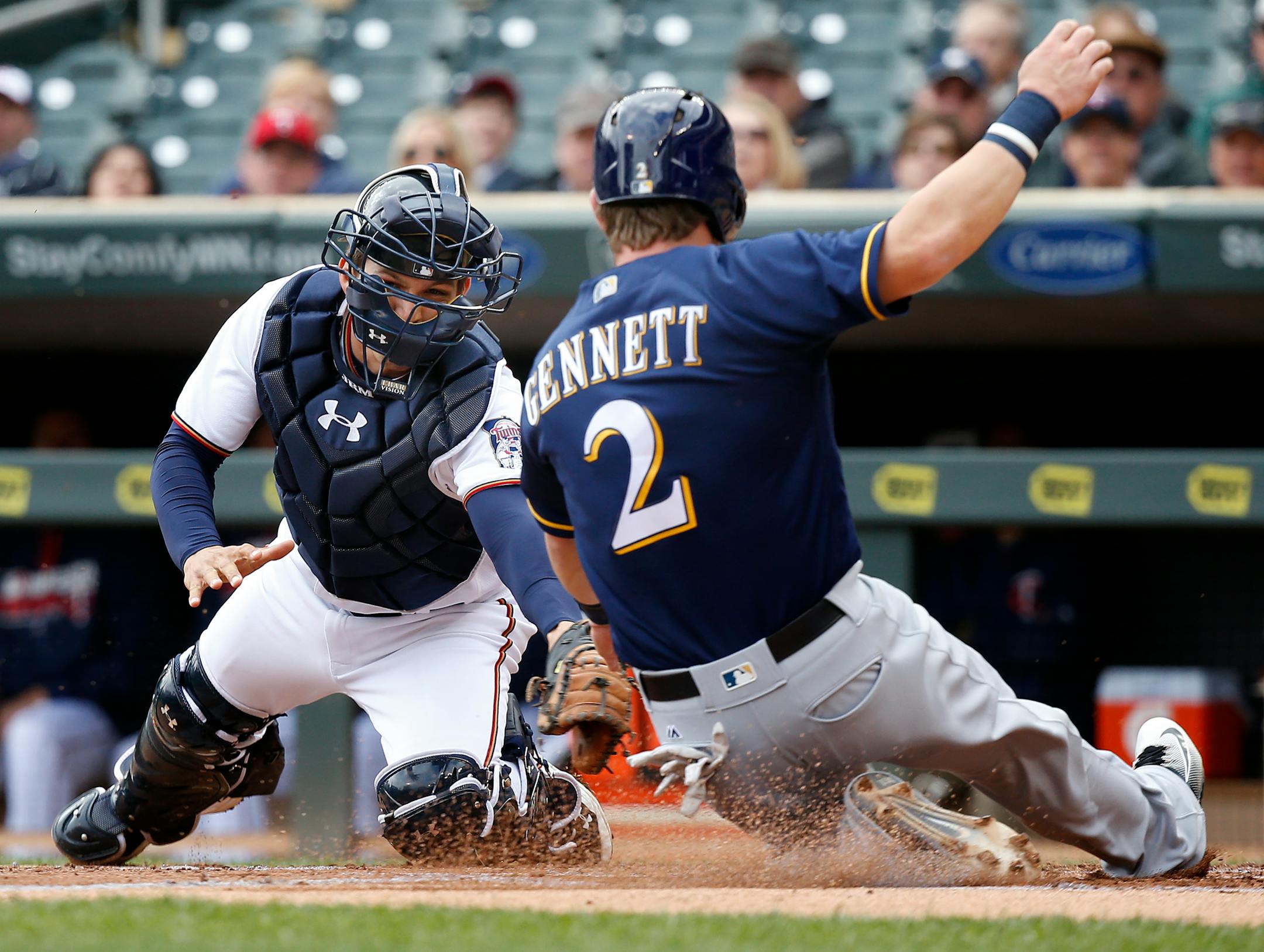 Scooter Gennett got past Twins catcher John Ryan Murphy earlier this week at Target Field in front o many empty seats.