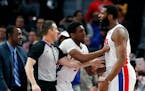Pistons guard Langston Galloway holds back center Andre Drummond after Timberwolves forward Taj Gibson fouled Drummond during the second half