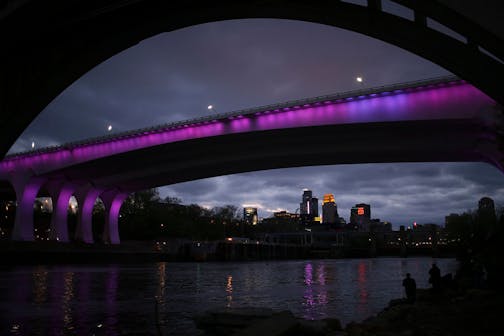 The I-35W bridge was bathed in purple Thursday night in a memorial to Prince.