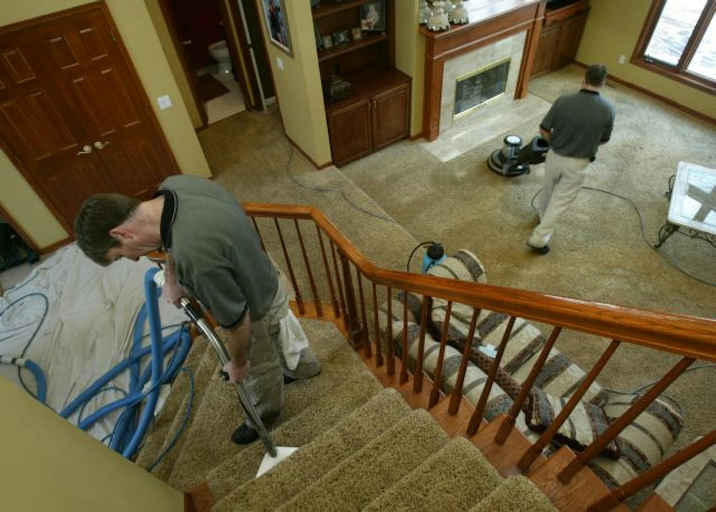 Rhett Trotter of Green Clean Care, steam cleans the stairway, while Tony White pretreated then scrubbed the carpet before the final carpet steam clean.