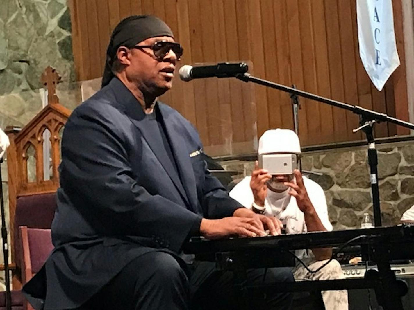 Musician Stevie Wonder joined a peace conference in Minneapolis and Saturday and urged those there to join the effort.