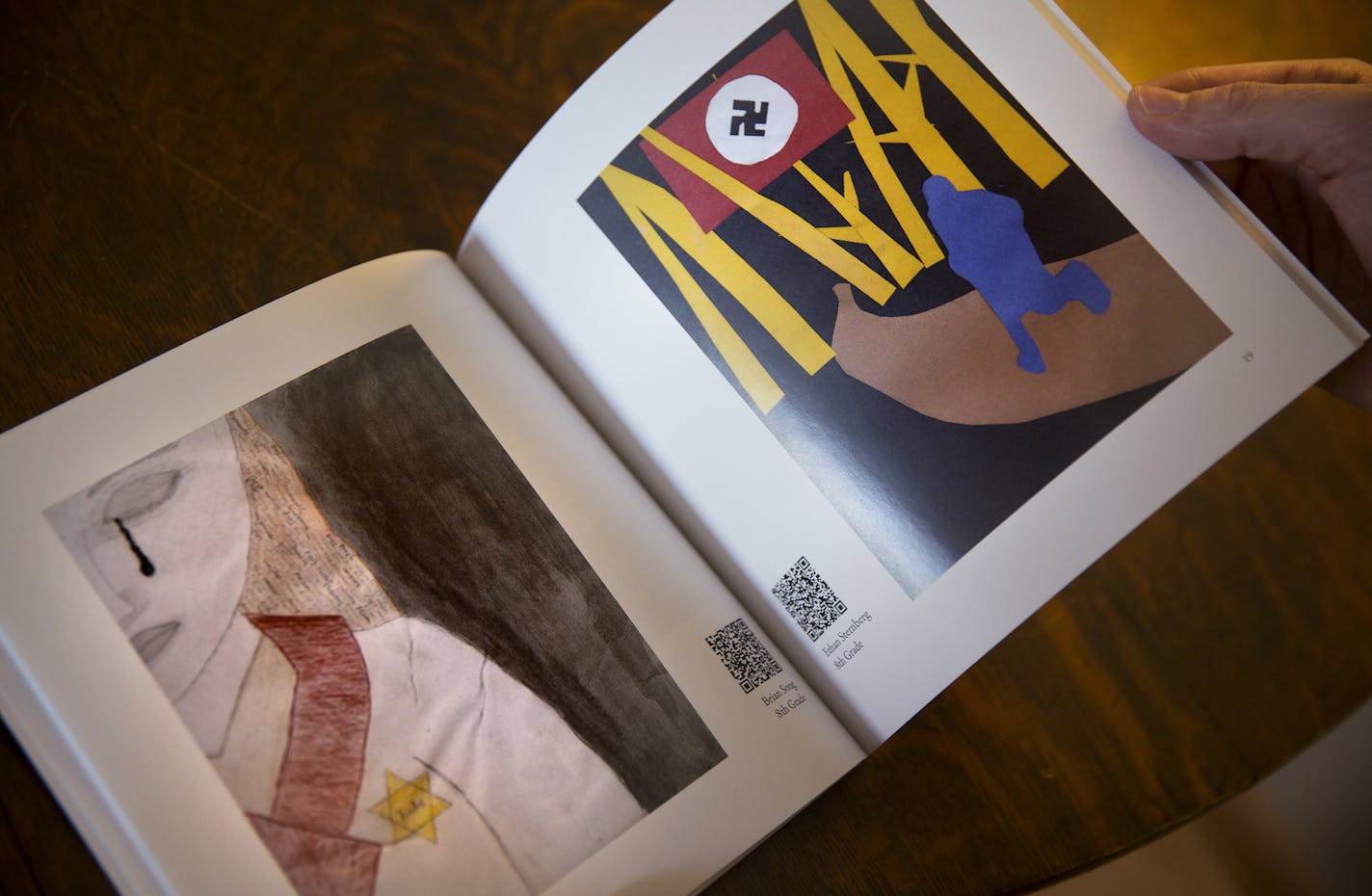 Local artist Rowan Pope holds a copy of the book "Six Chairs: A Holocaust Survivor's Story" which was illustrated by Breck Middle School students. ] LEILA NAVIDI leila.navidi@startribune.com / BACKGROUND INFORMATION: Friday, January 30, 2015. Rowan Pope, in collaboration with Breck Middle School, wrote the book "Six Chairs: A Holocaust Survivor's Story" which was illustrated by Breck Middle School students, about local Holocaust survivor Joe Grosnacht.