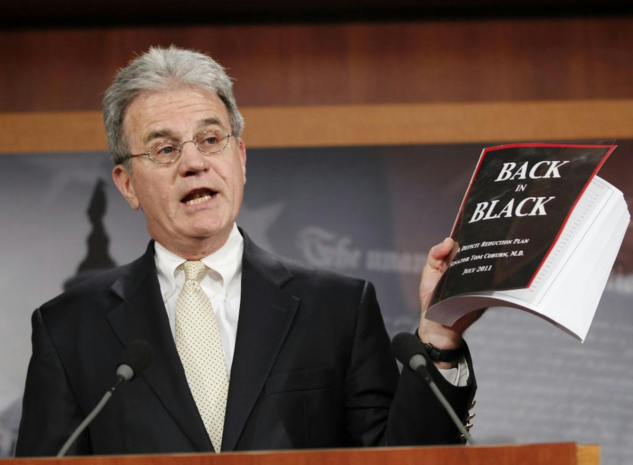 Sen. Tom Coburn, R-Okla. reveals his "Back in Black" plan to reduce the federal deficit, Monday, July 18, 2011, during a news conference on Capitol Hill in Washington.
