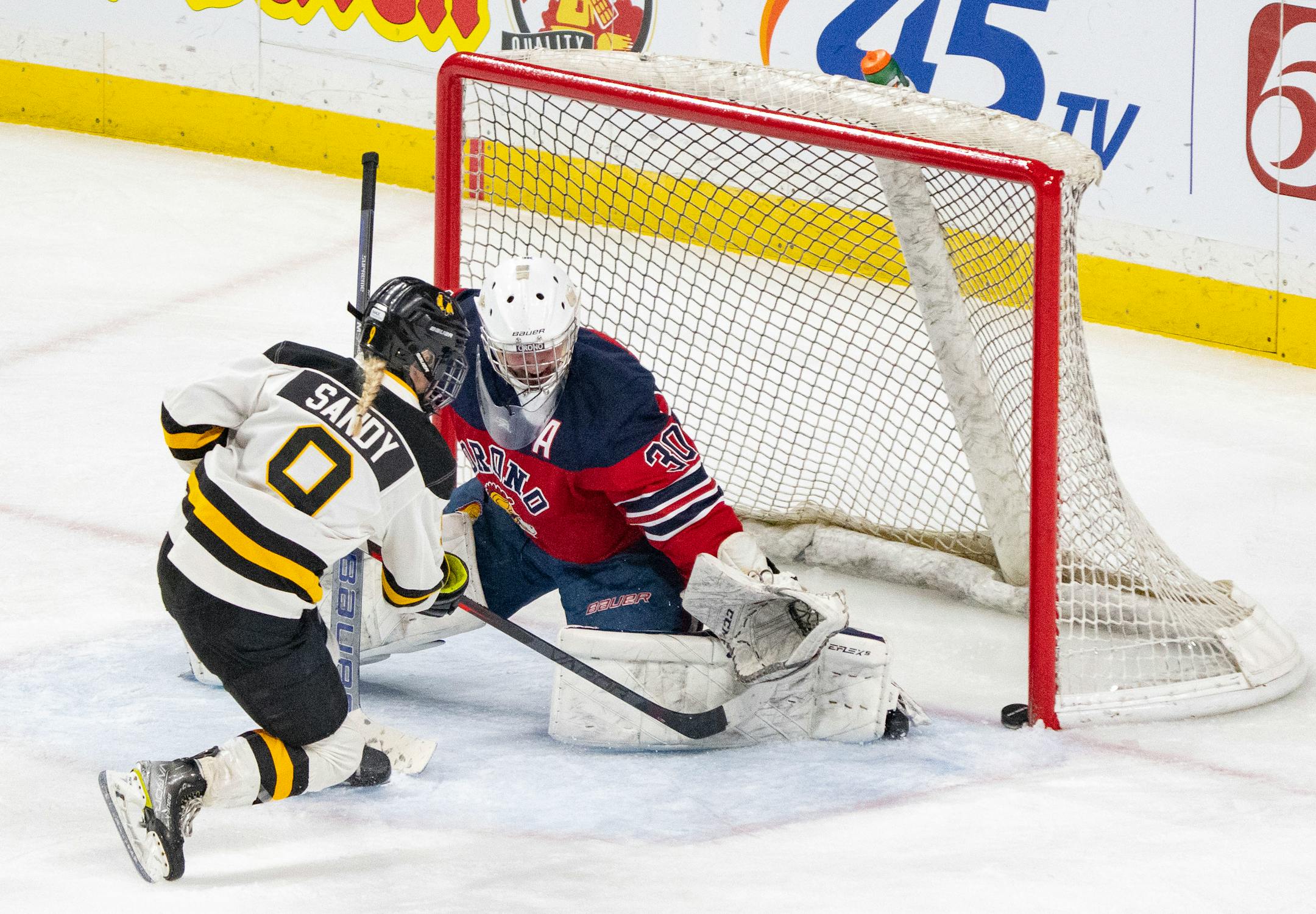 Warroad forward Kaiya Sandy (9) scores a goal on Orono goaltender Celia Dahl (30) in the second period.