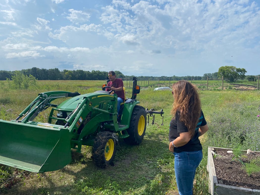 Lisa Brunner, director of White Earth Tribal and Community College Extension, watched as a tractor passed on July 19, 2022.