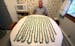 Ben Barnes, 75, a retired bartender, in front of a table full of rings made by Barnes from dollar bills.