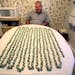 Ben Barnes, 75, a retired bartender, in front of a table full of rings made by Barnes from dollar bills.