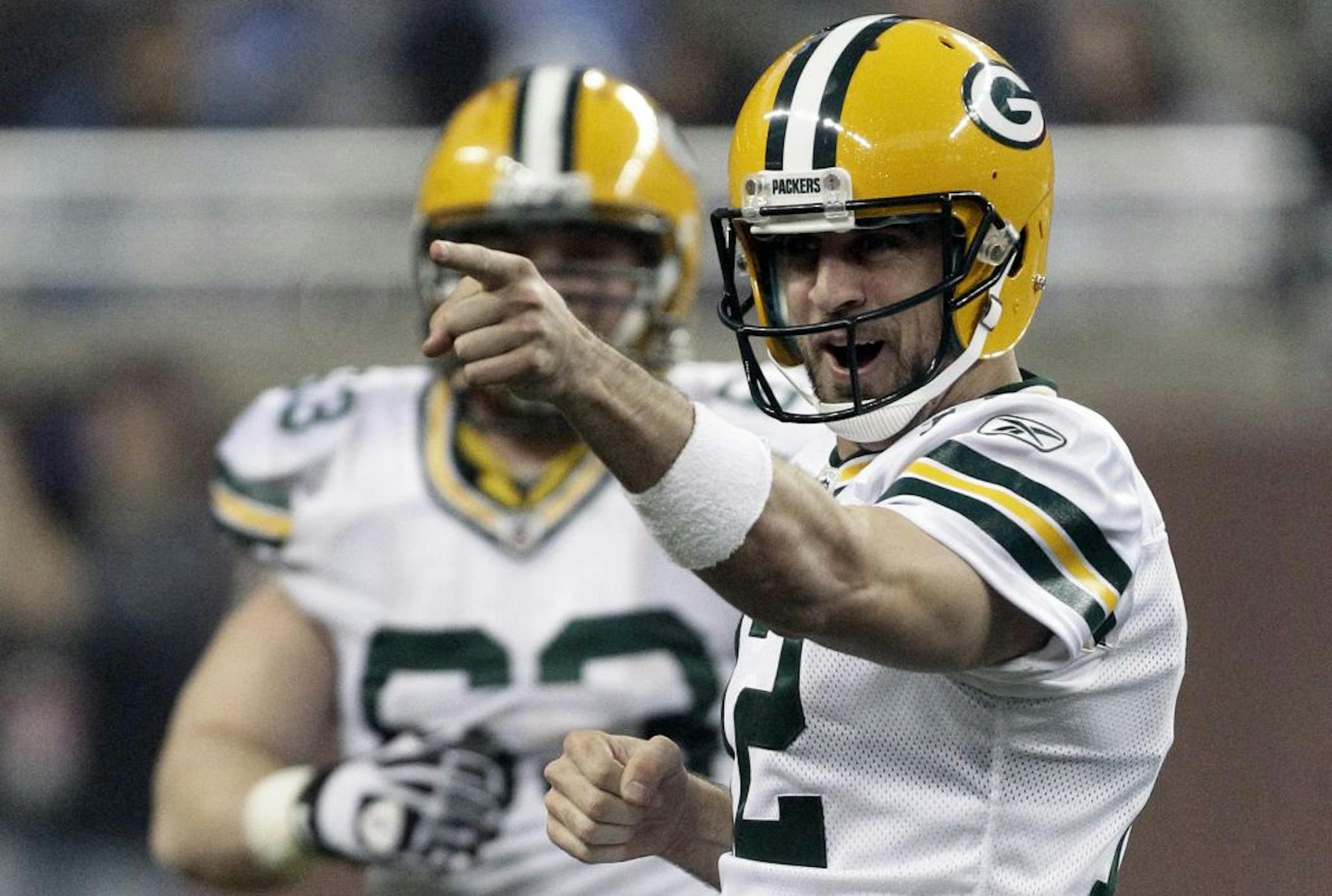 Packers quarterback Aaron Rodgers (right) celebrated after throwing a 65-yard touchdown pass to teammate James Jones in Green Bay's 27-15 victory over Detroit on Thursday. The Packers are now 11-0 this season.