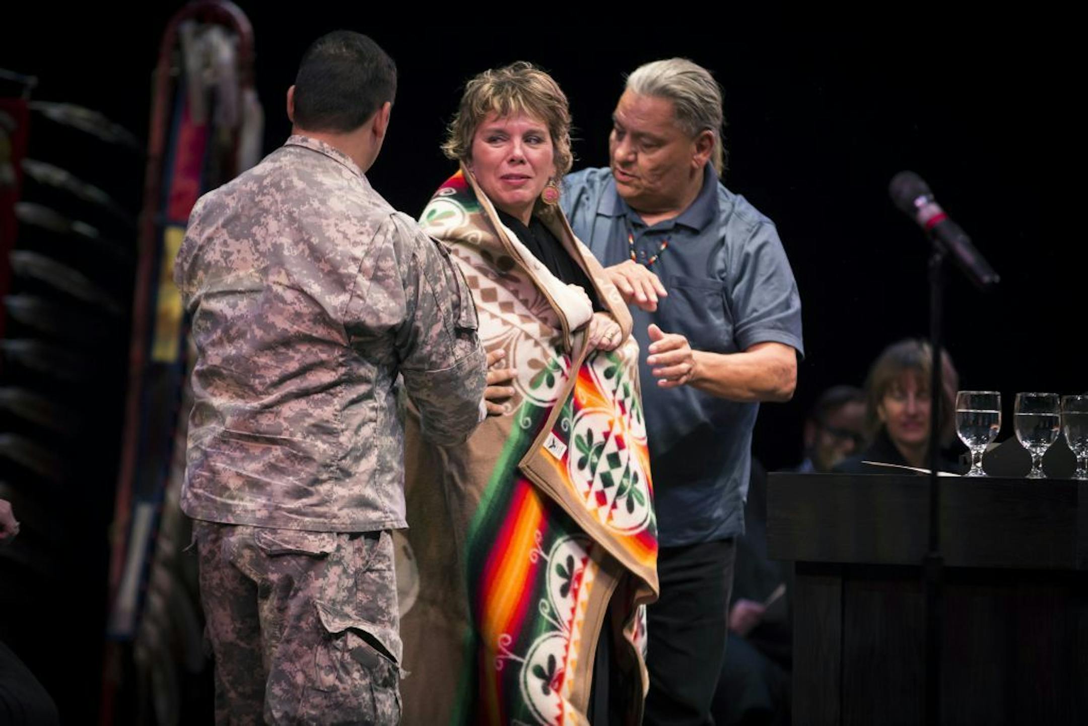 Justice Anne K McKeig was wrapped in a Pendleton blanket by White Earth Tribal Council members after she was sworn into the Minnesota Supreme Court at St. Catherine University in St. Paul, Minn., on Thursday, September 15, 2016. Mckeig is a descendant of the White Earth Band of Ojibwe and becomes the first American Indian to serve on the Minnesota Supreme Court.