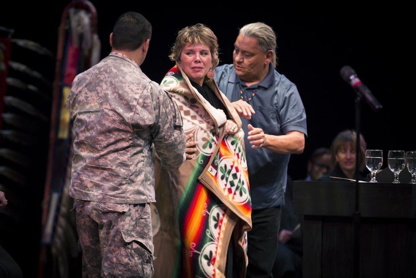 Justice Anne K McKeig was wrapped in a Pendleton blanket by White Earth Tribal Council members after she was sworn into the Minnesota Supreme Court at St. Catherine University in St. Paul, Minn., on Thursday, September 15, 2016. Mckeig is a descendant of the White Earth Band of Ojibwe and becomes the first American Indian to serve on the Minnesota Supreme Court.