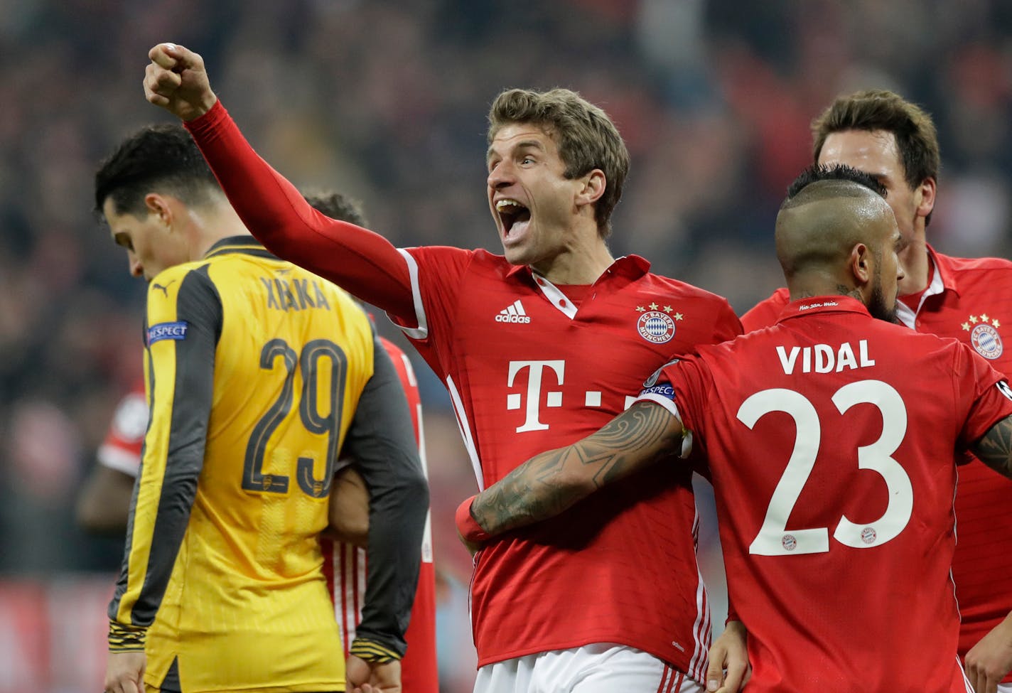 Bayern's Thomas Mueller, center, celebrates after scoring his side's fifth goal during the Champions League round of 16 first leg soccer match between FC Bayern Munich and Arsenal, in Munich, Germany, Wednesday, Feb. 15, 2017. (AP Photo/Matthias Schrader)