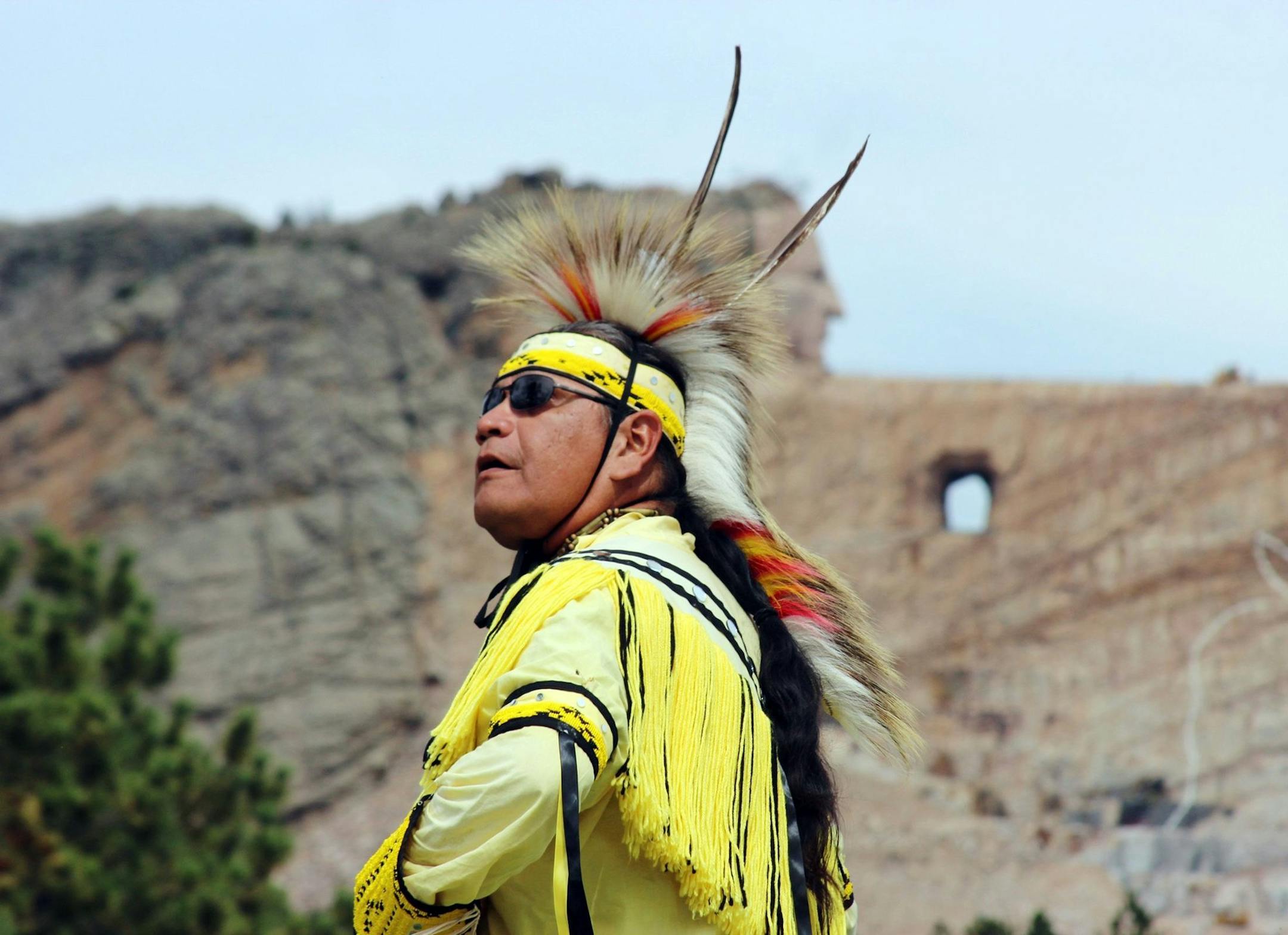 A Native American dancer shows the steps of traditional dances at the Crazy Horse Memorial in southwest South Dakota, 17 miles from Mount Rushmore. With the 87-foot-tall head of Crazy Horse finished and sculptors working on the outstretched arm, it is progressing - but it will likely be beyond our lifetimes before the world's biggest sculpture is finished. (Ellen Creager/Detroit Free Press/MCT) ORG XMIT: 1157519