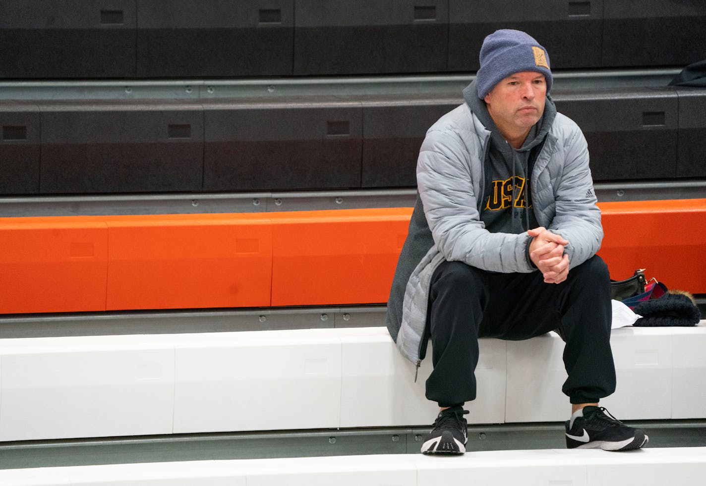 David Flom, the suspended head coach of the Eden Prairie boy's basketball team watches their game against Farmington from the bleachers Friday, Dec. 16, 2022 at Farmington High School in Farmington, Minn. ]