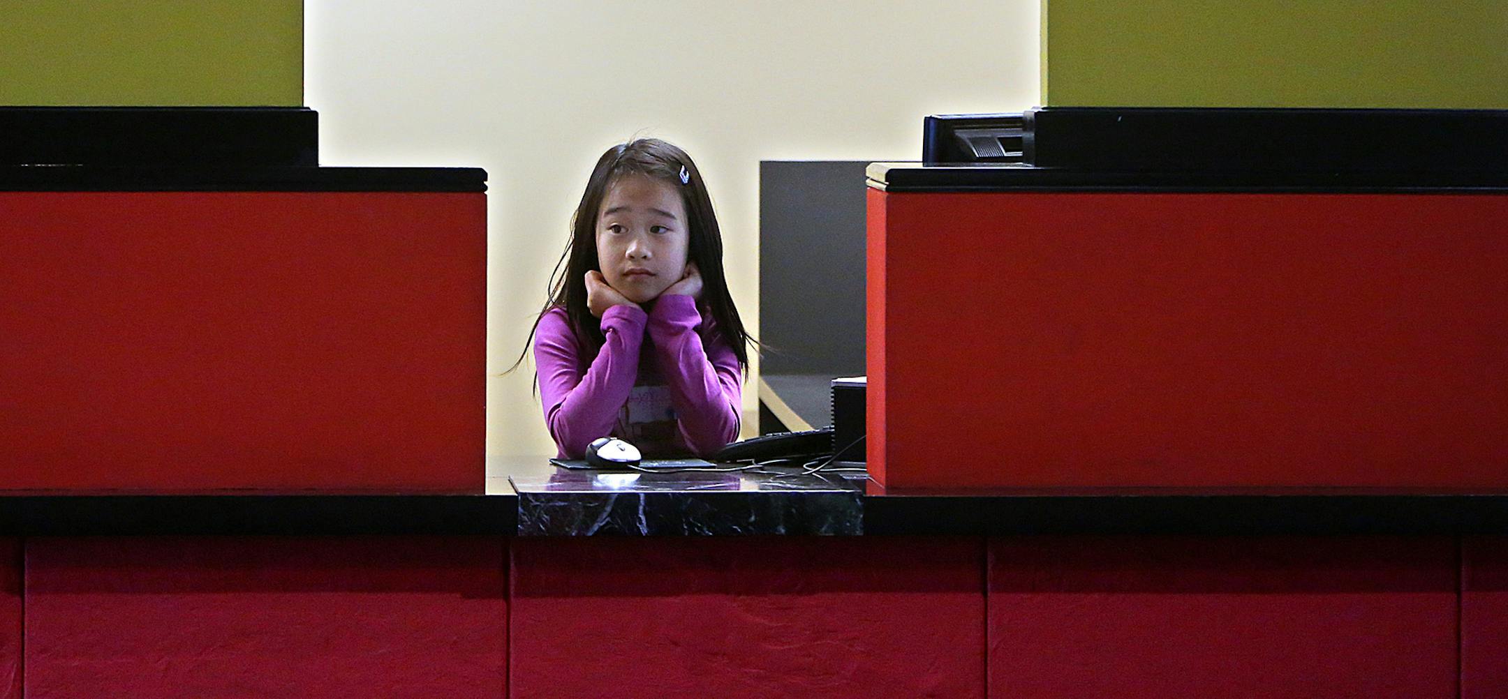 Greenleaf Elementary School student and bank teller Lynn Dinh, 10, waited for the workday to begin. ] (JIM GEHRZ/STAR TRIBUNE) / April 2, 2013 / 11:00 AM Maplewood, MN ‚Äì BACKGROUND INFORMATION- Fourth and 5th grade Students from Greenleaf and Westview Elementary schools in the Rosemount-Apple Valley-Eagan School District spent a day recently learning how to run a business in a program put on by Junior Achievement. Students learned how to do payroll and taxes and pay utilities