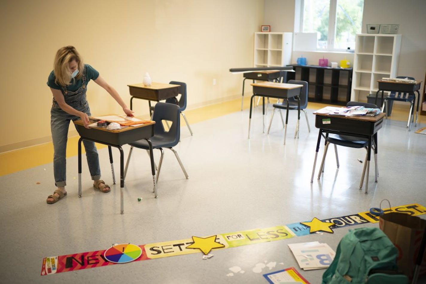 Haley Puckhaber positioned the desks in her fourth-grade classroom at safe distances for incoming students at Friendship Academy for the Arts while getting her new classroom ready for the school year.