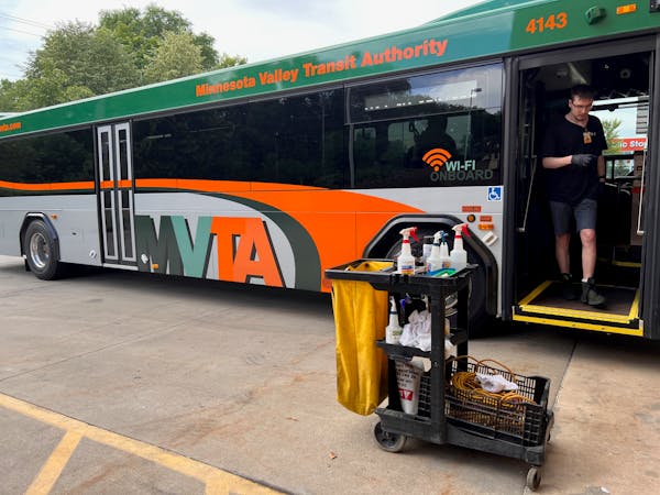 Asher Tholl, an employee of Schmitty & Sons, steps off a bus he was cleaning at the Minnesota Valley Transit Authority in Eagan Monday. He is one of f
