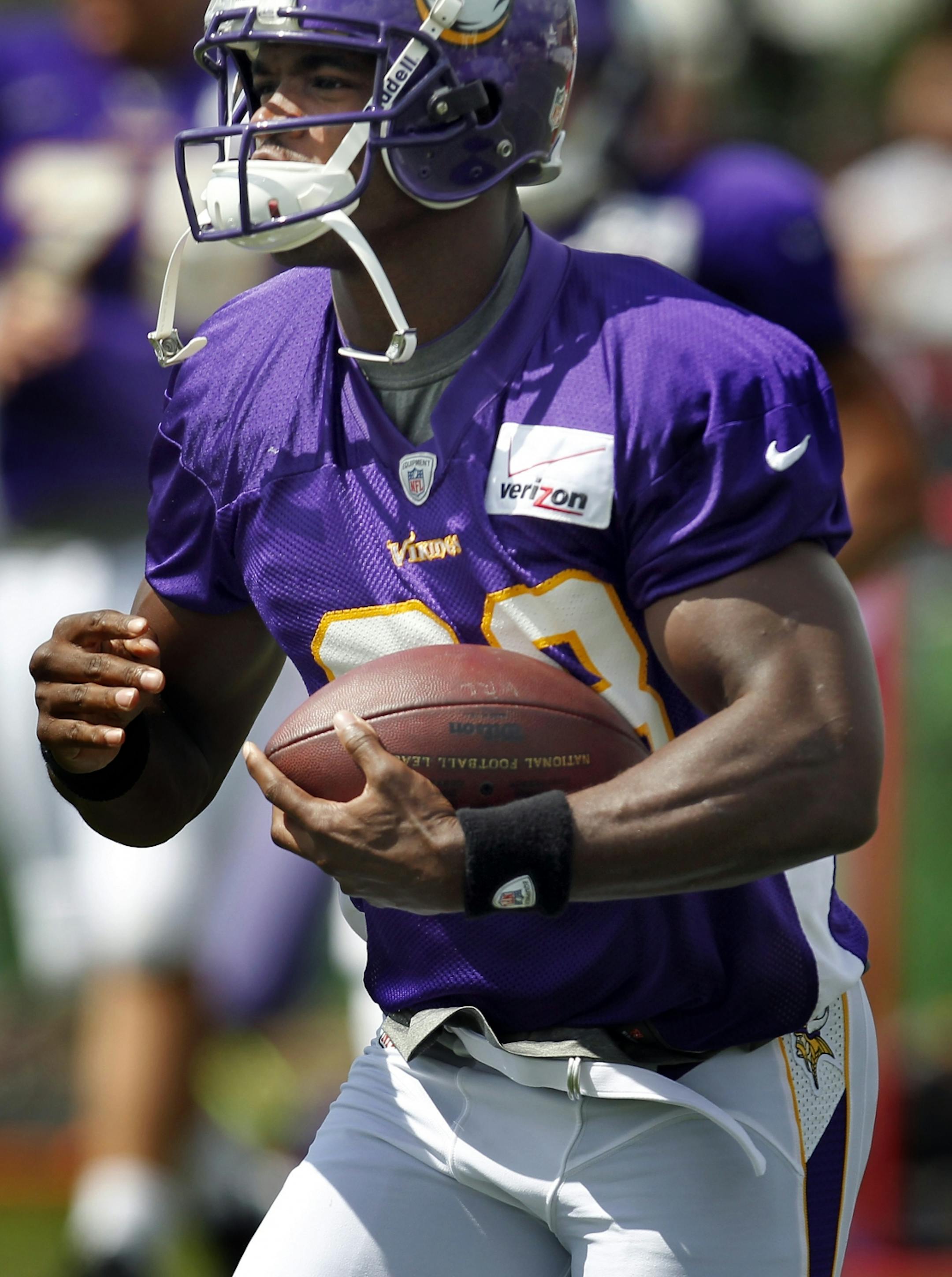 Minnesota Vikings running back Adrian Peterson (28) took a handoff during the afternoon practice on Monday. .