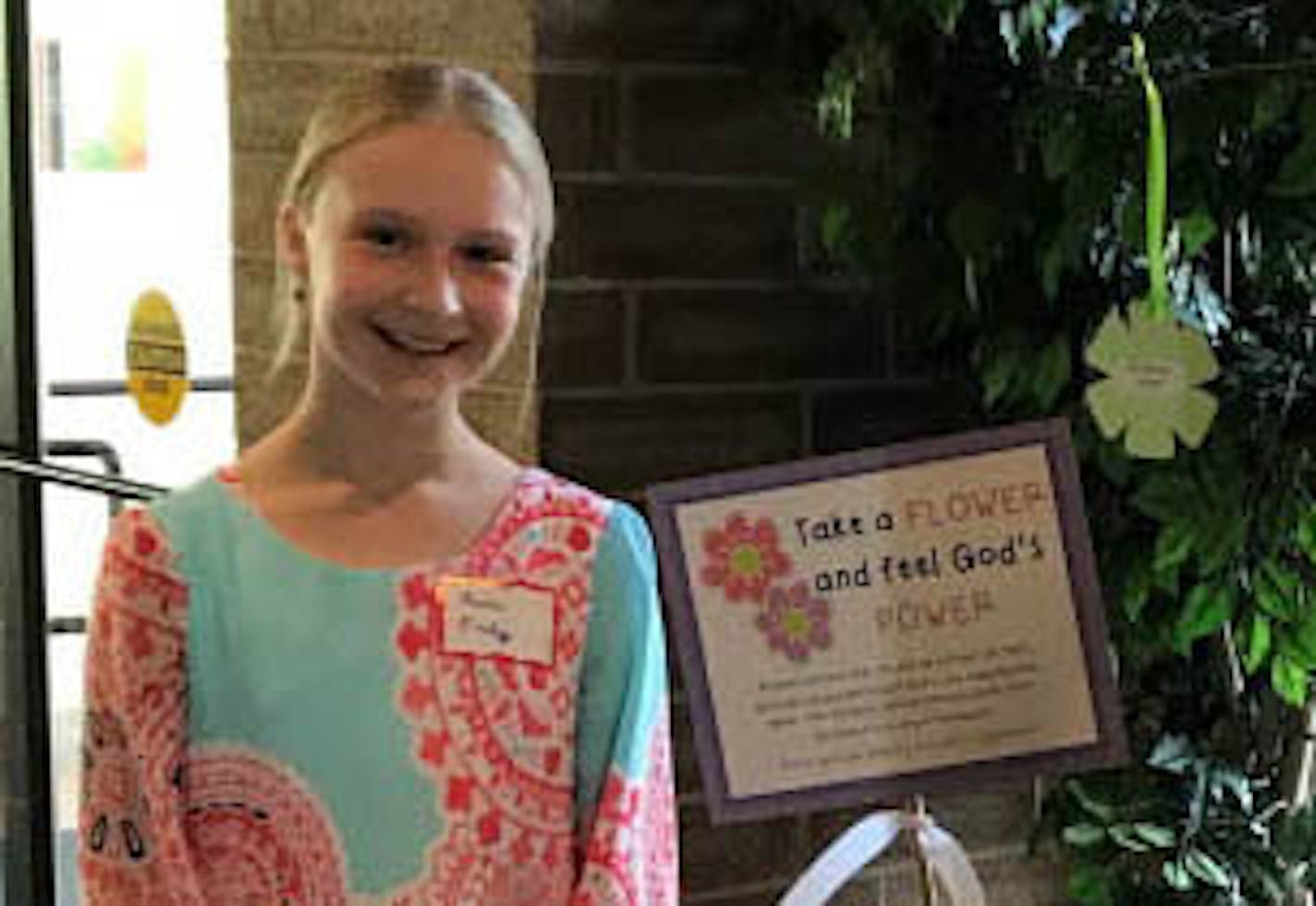 Eleanor Donley stands in front of the "giving tree" used in the donation drive she led to help the homeless.