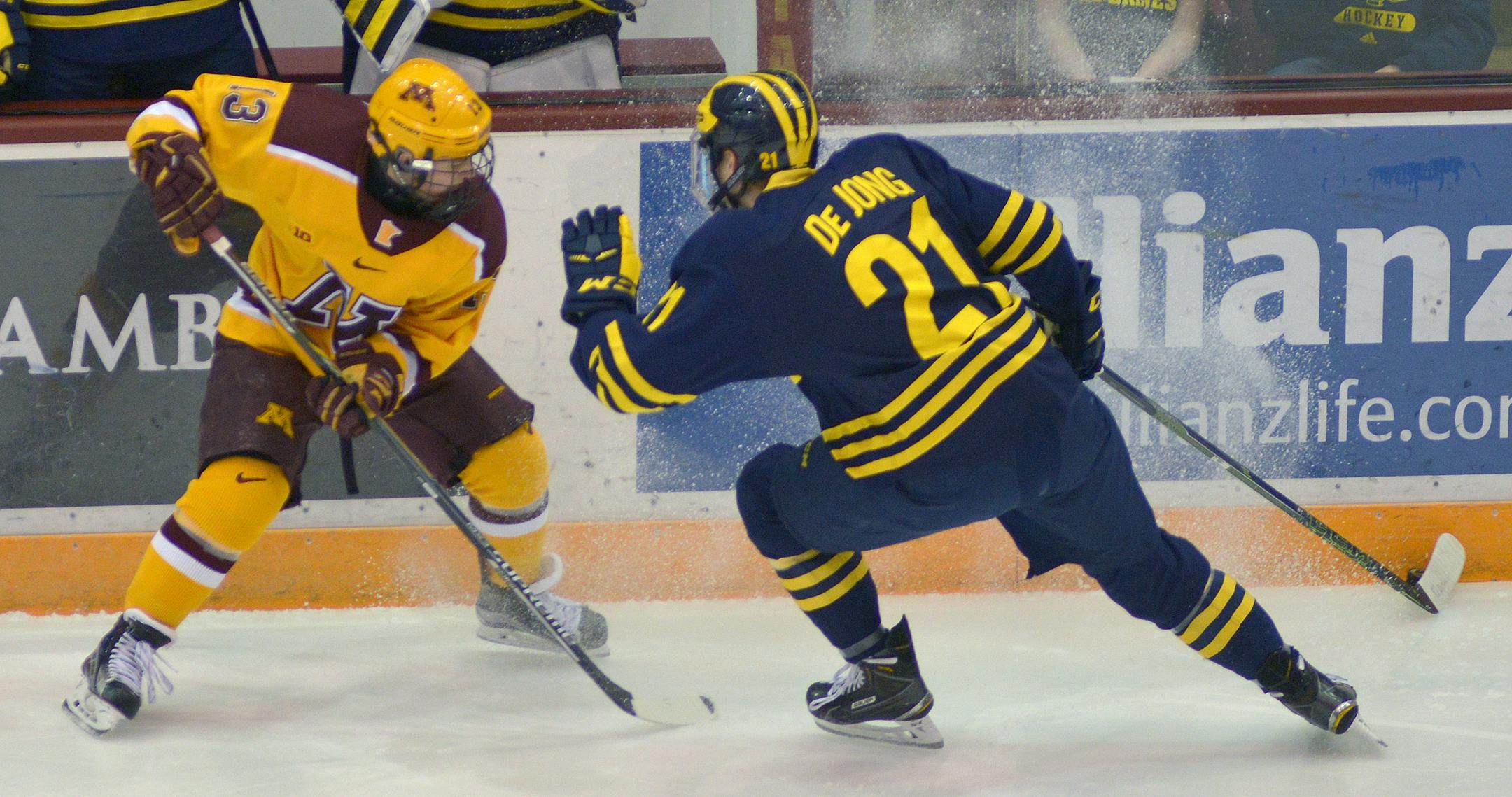 Minnesota left wing Taylor Cammarata battles with Michigan defenseman Nolan De Jong during the first period.