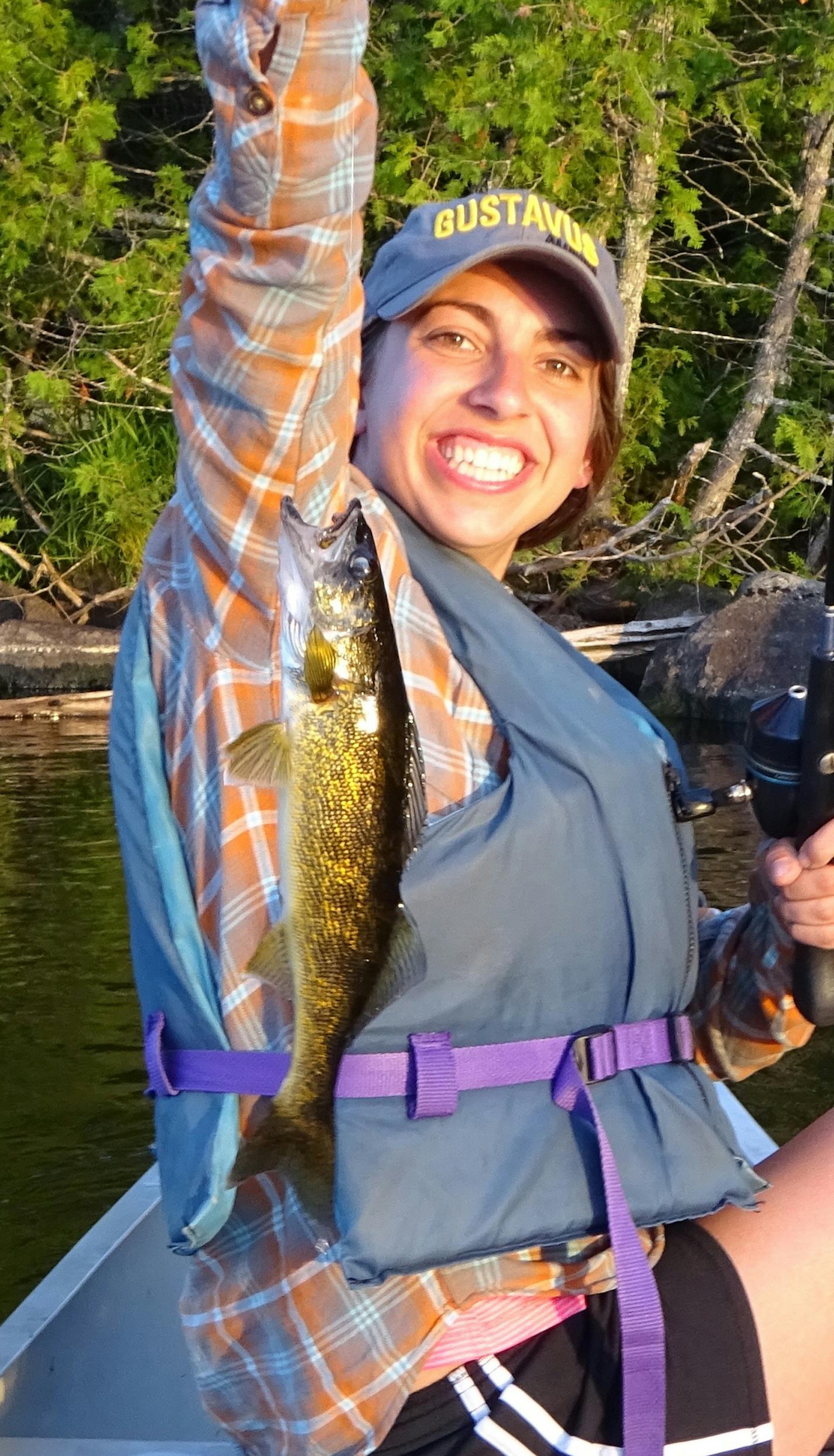 FIRST FISH Katie Frehner, 22, of Roseville, caught this 15-inch walleye on a BWCA lake while jigging at dusk from her canoe. It was her first experience landing, unhooking and releasing a fish on her own.