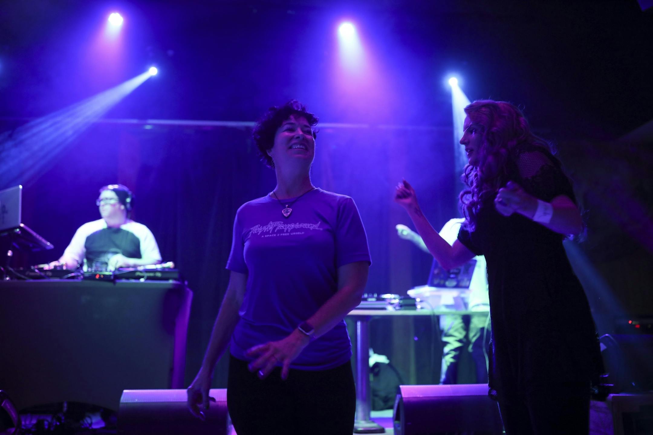 Heidi Vader, left, danced with Sara Sauser early at her organization's "Free Urself Dance Party" Wednesday night.
