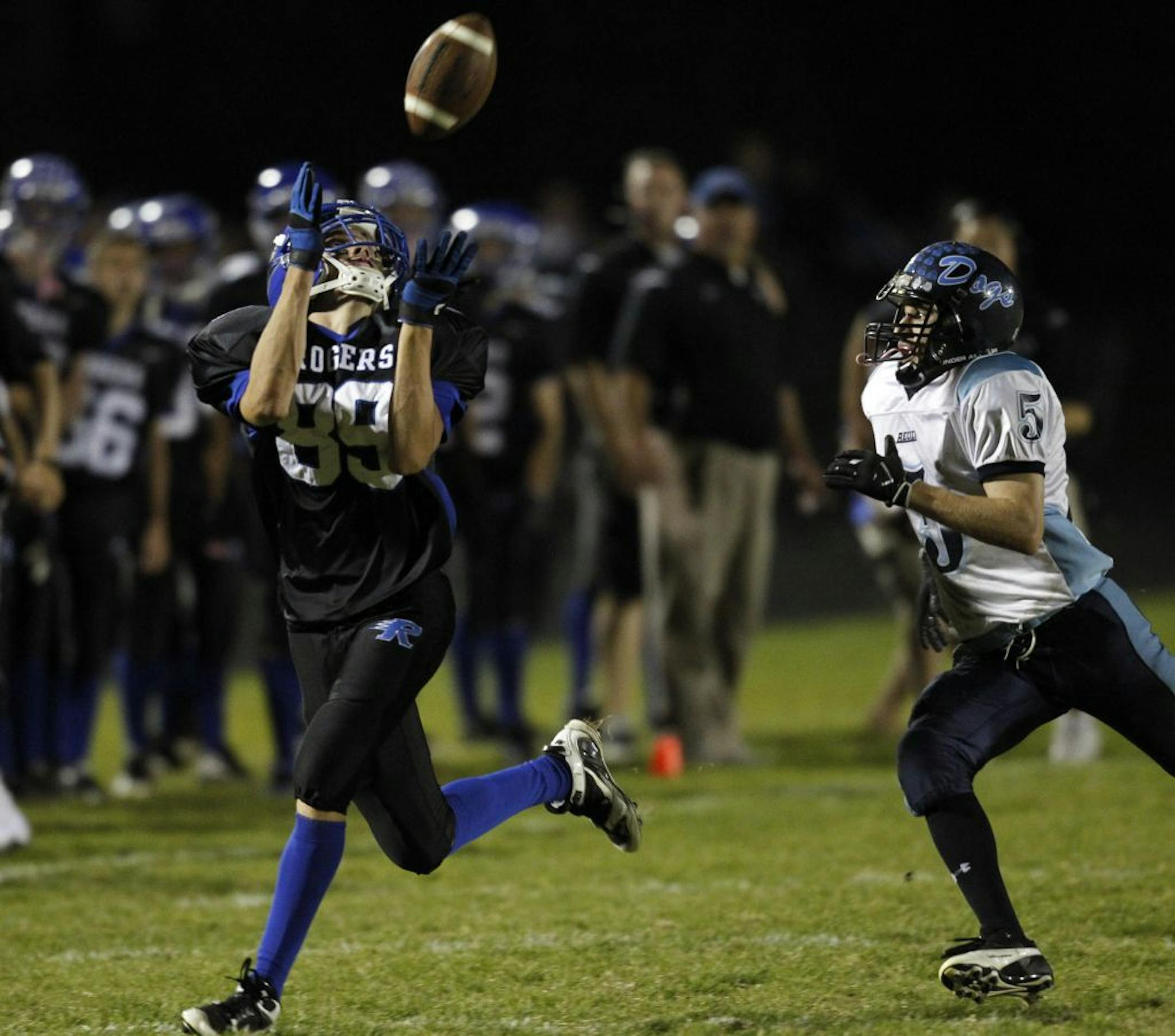 At the Becker vs Roger homecoming game, WR Andrew Smith makes a long yardage reception as cornerback Brett Watercott catches up to him to make a tackle.