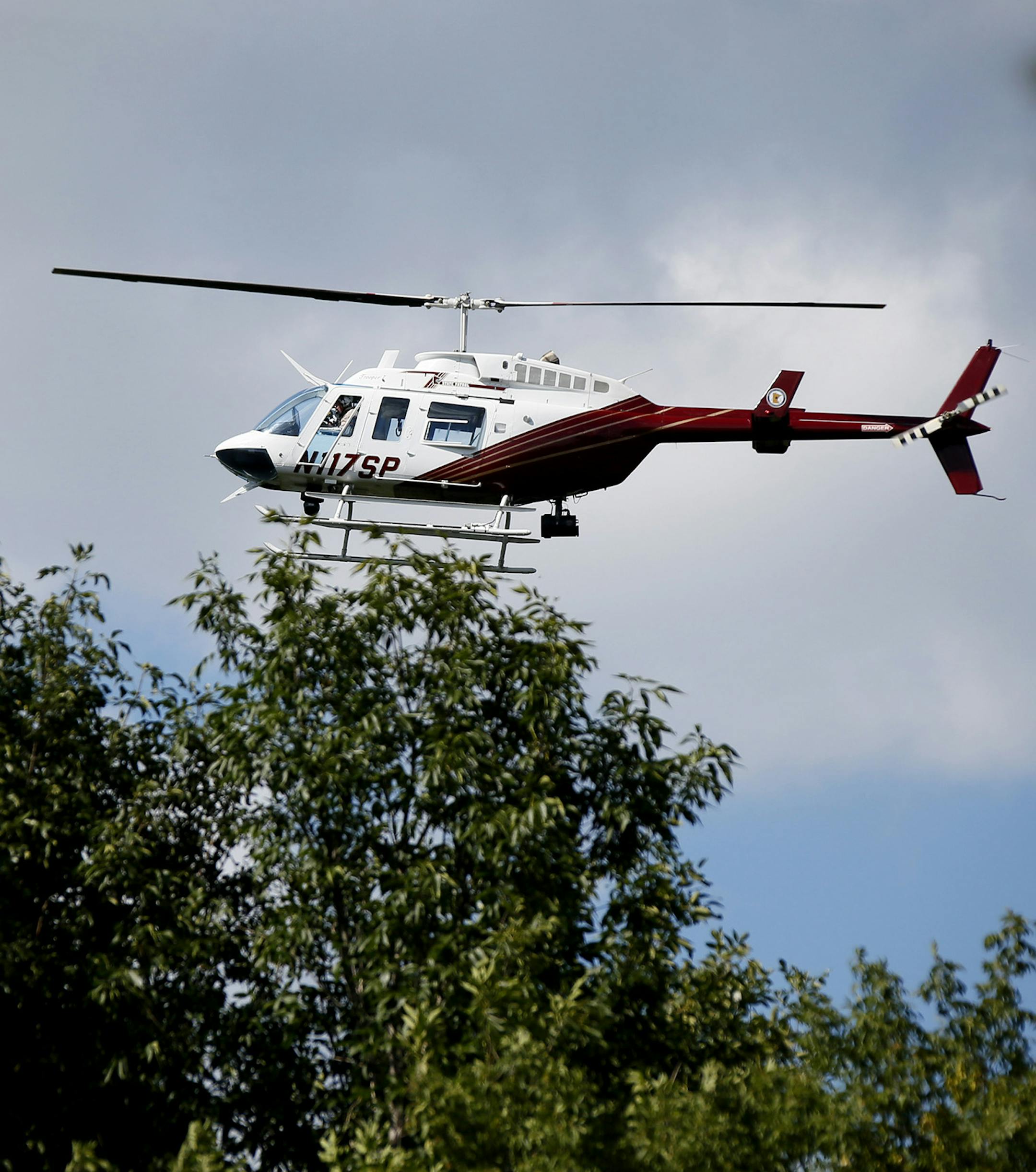 A state patrol helicopter flew over a wooded area in Blaine near Highway 65 and highway 10 for wanted alleged murderer Lyle "Ty" Hoffman who also may be the suspect in a Blaine bank robbery, police say.Monday September 1 , 2014 in Blaine MN . ] Jerry Holt Jerry.holt@startribune.com